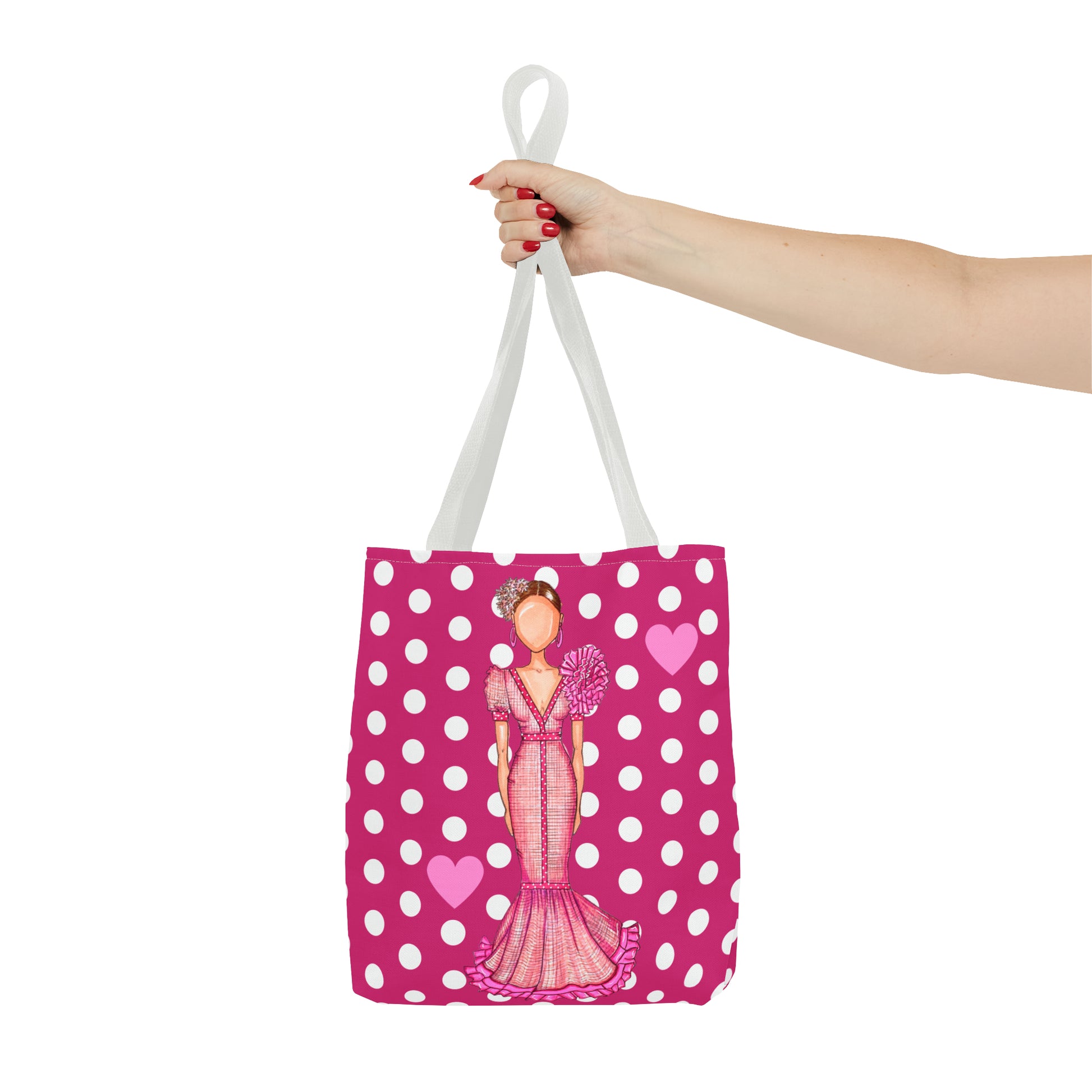 a woman's hand holding a pink shopping bag with a picture of a woman