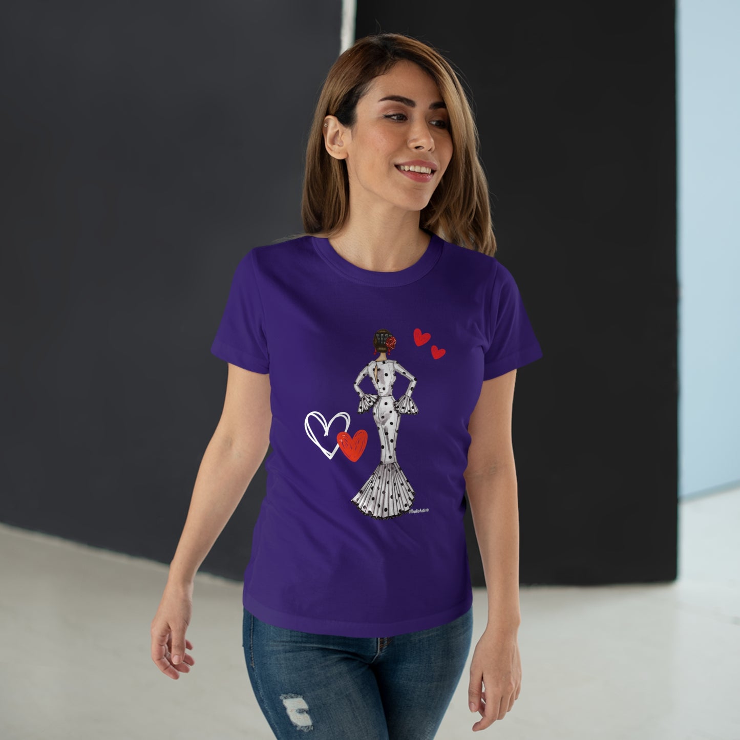 a woman wearing a purple t - shirt with a picture of a woman holding a