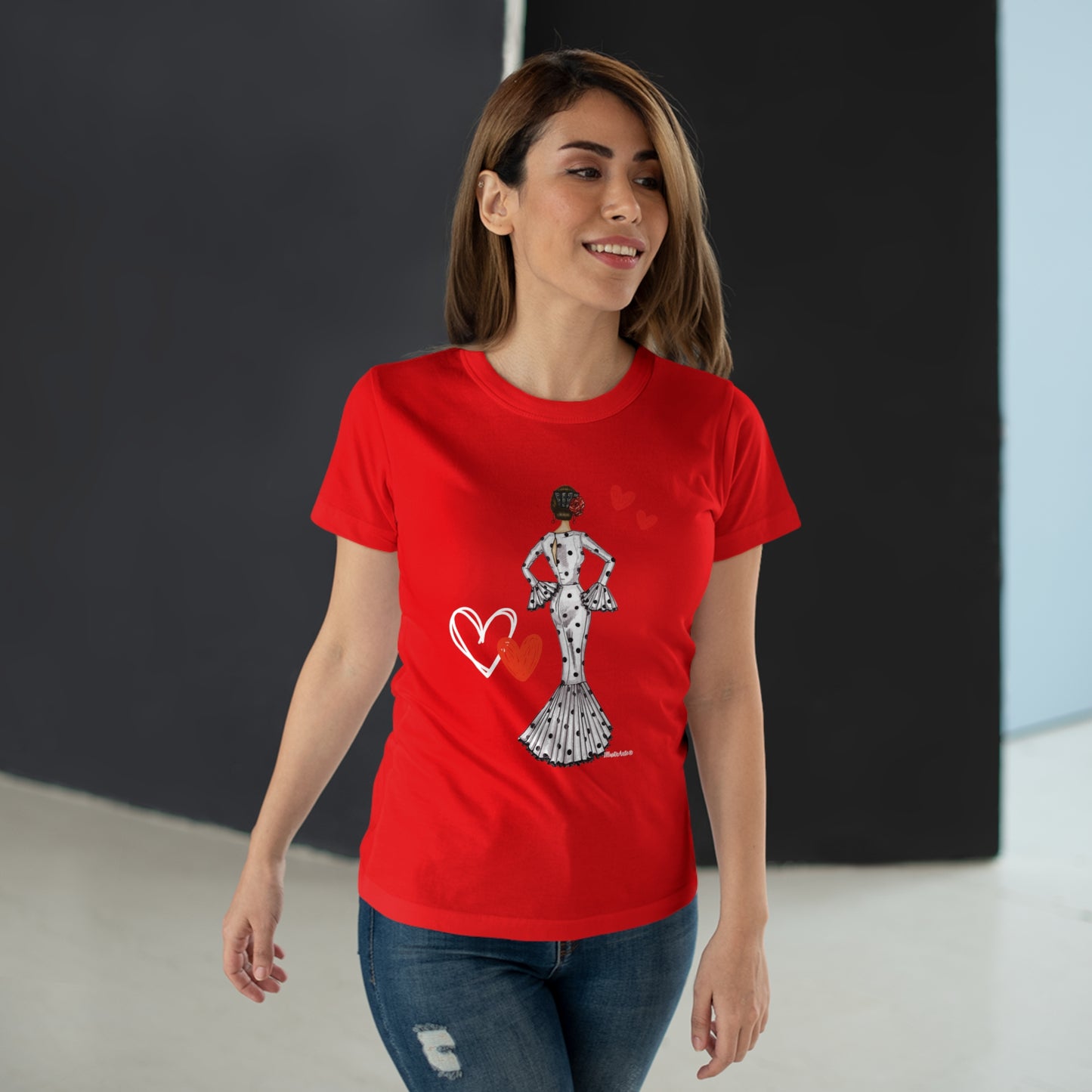 a woman wearing a red t - shirt with a heart on it
