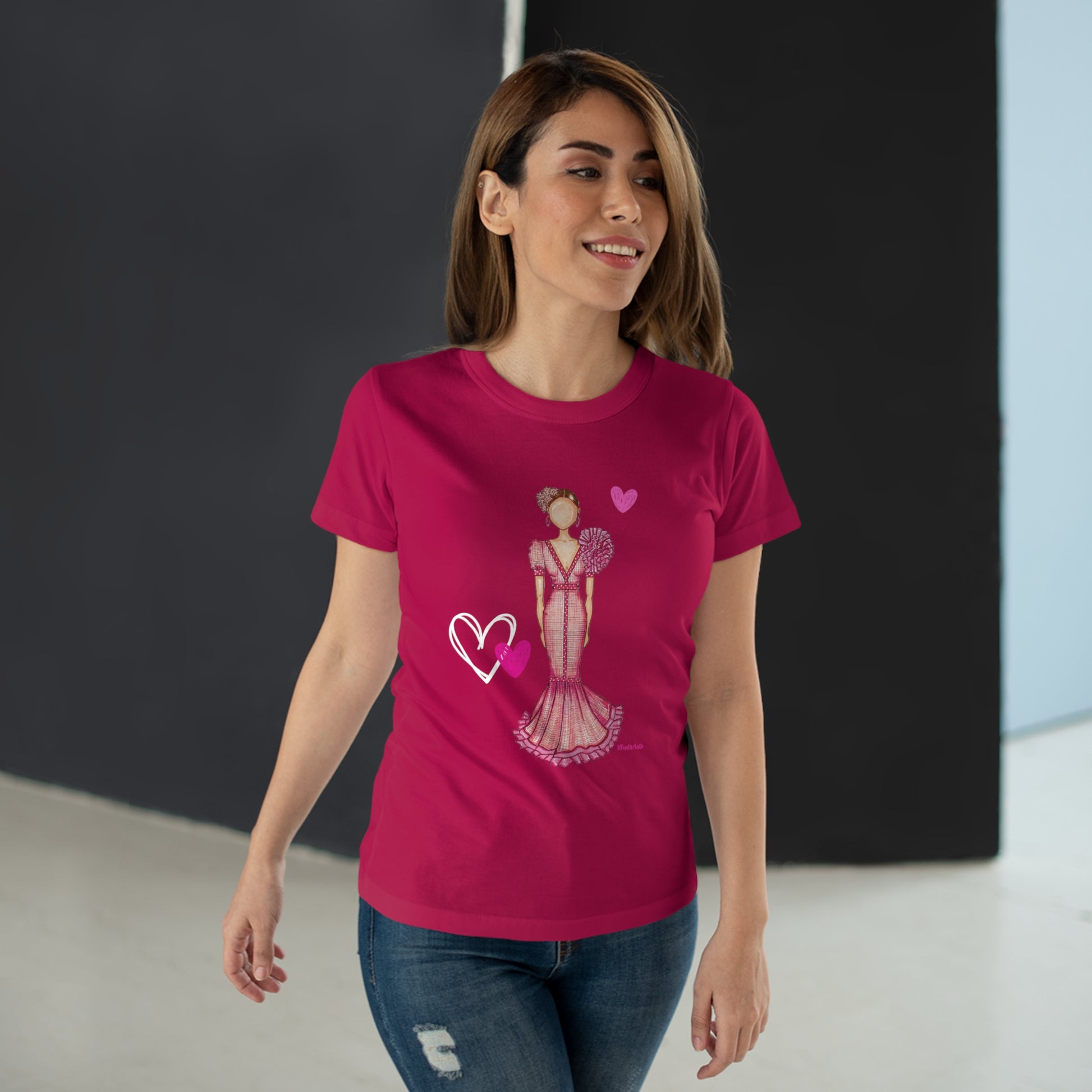 a woman wearing a pink t - shirt with a dress and heart on it