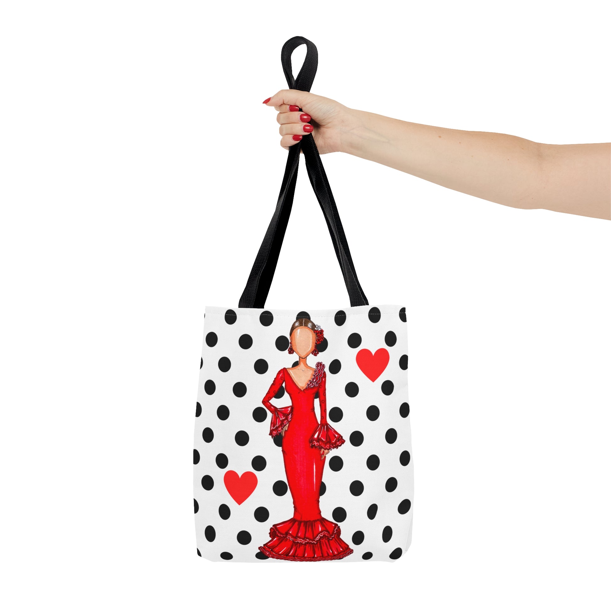 a woman's hand holding a tote bag with a picture of a woman