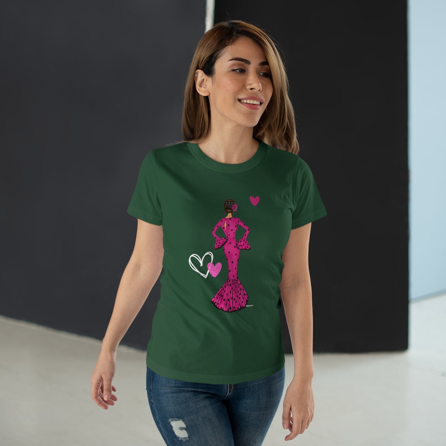 a woman wearing a green t - shirt with a pink princess on it