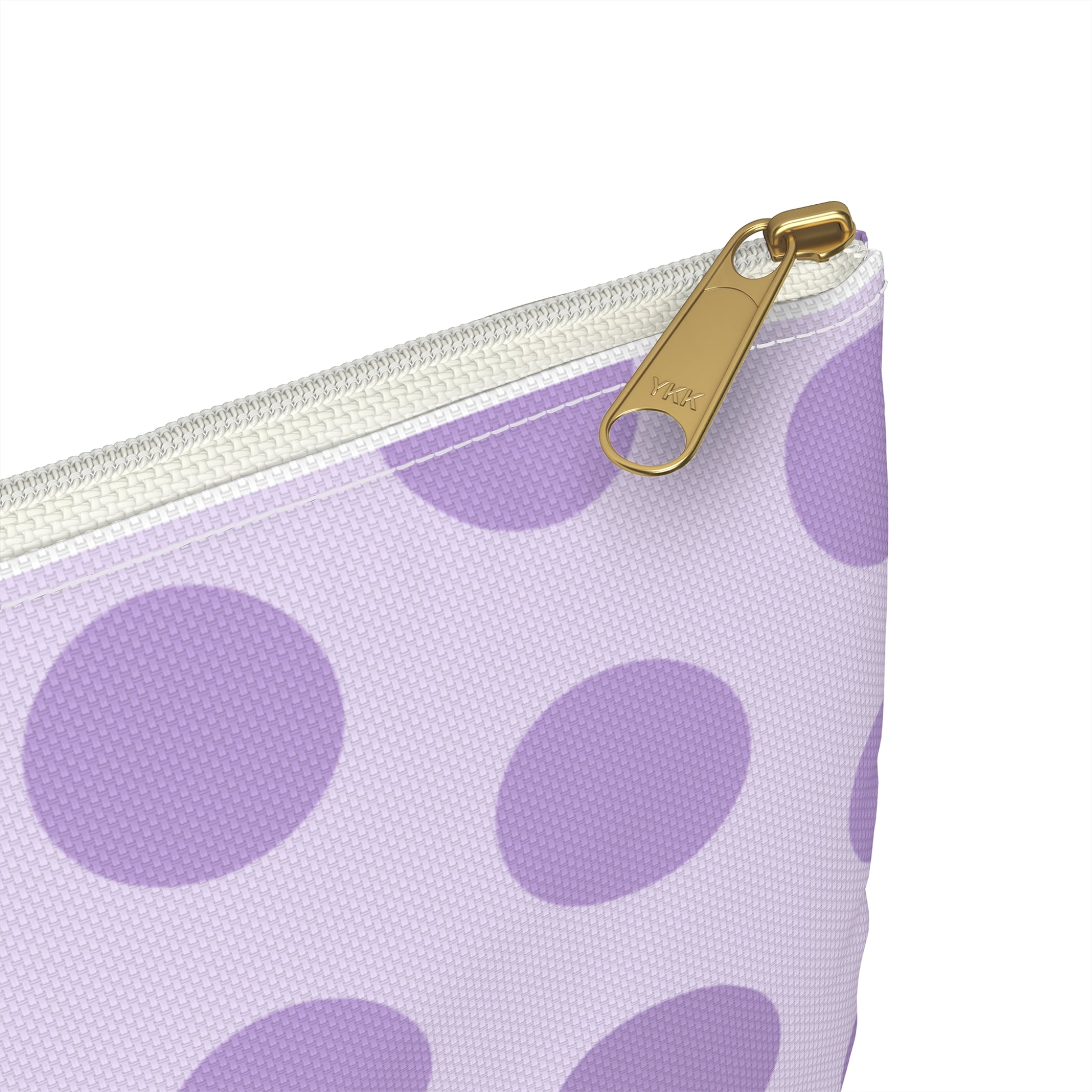 a purple and white polka dot purse with a gold hook
