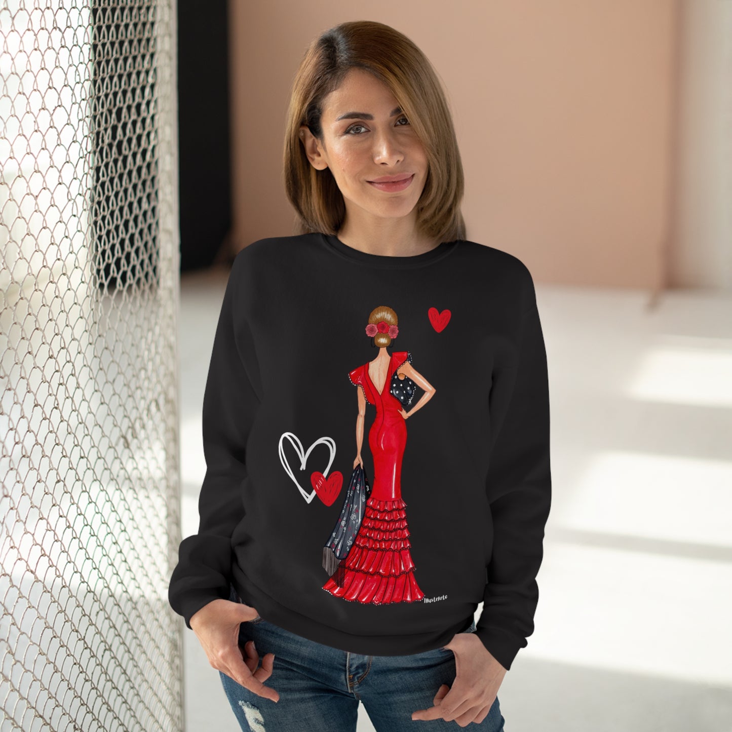 a woman wearing a black sweater with a picture of a woman in a red dress