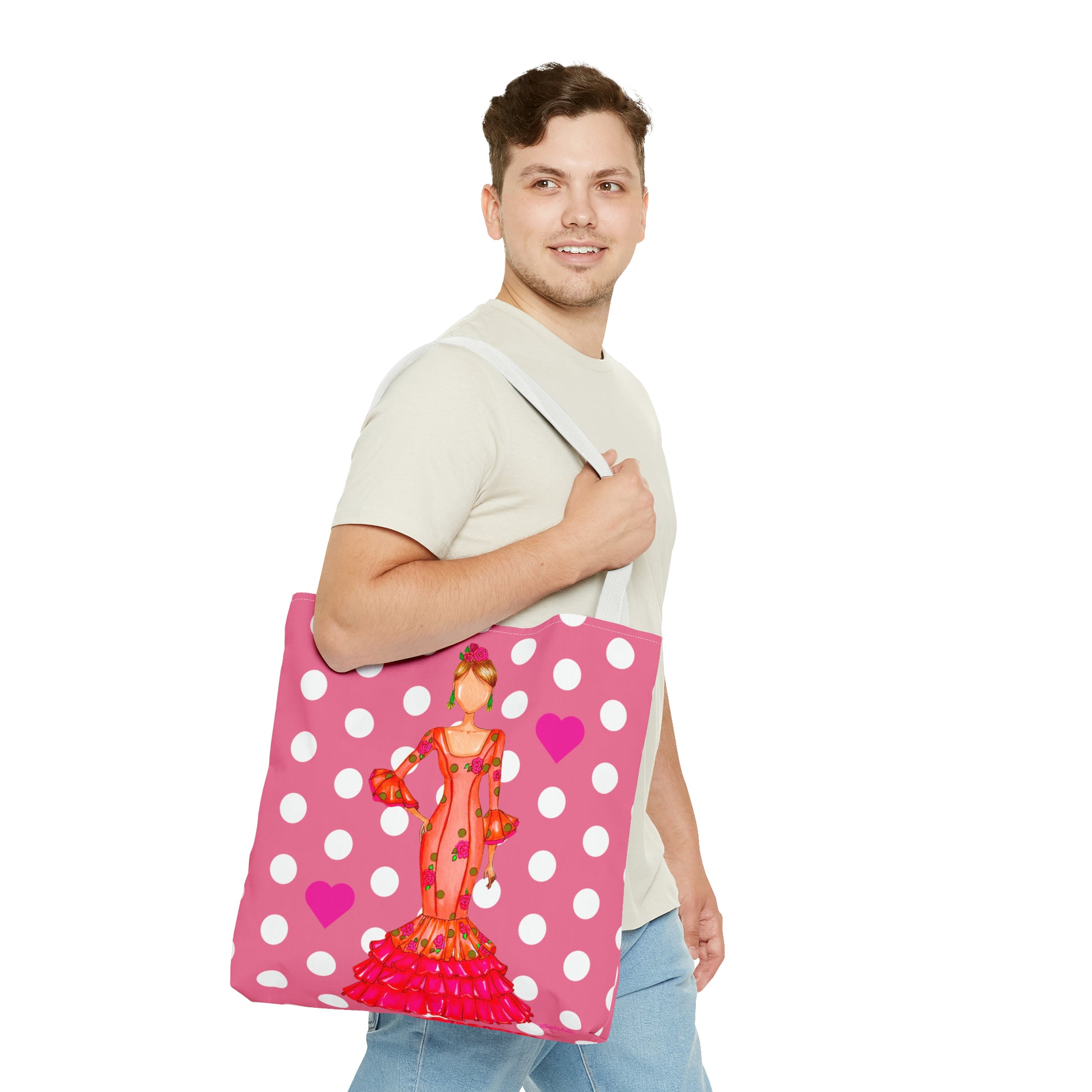 a man holding a pink and white polka dot bag