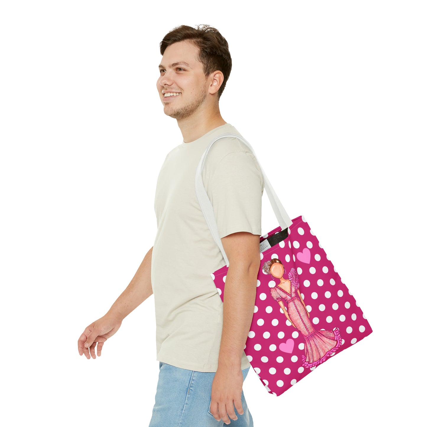 a man carrying a pink and white polka dot bag