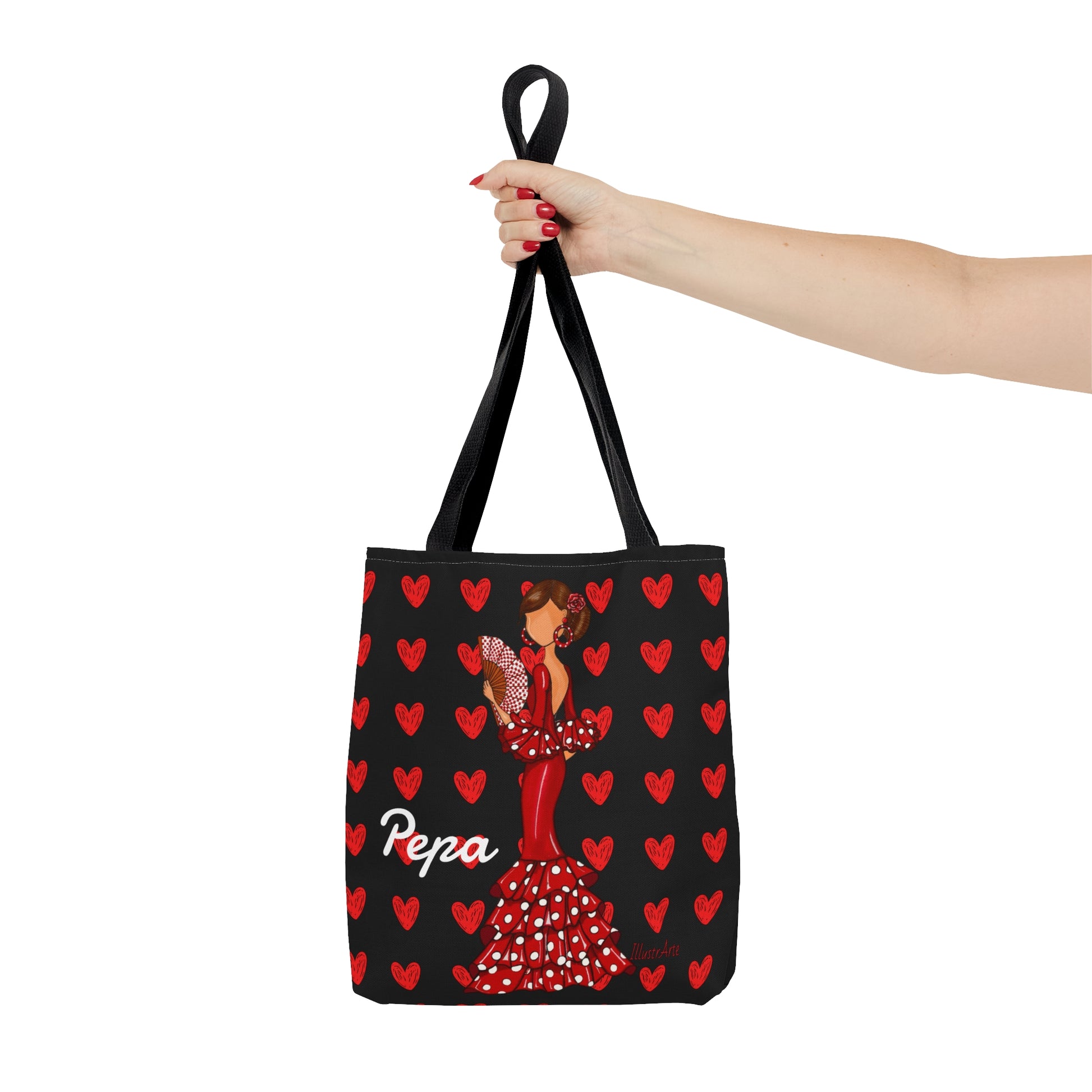 a woman's hand holding a black and red bag with a picture of a