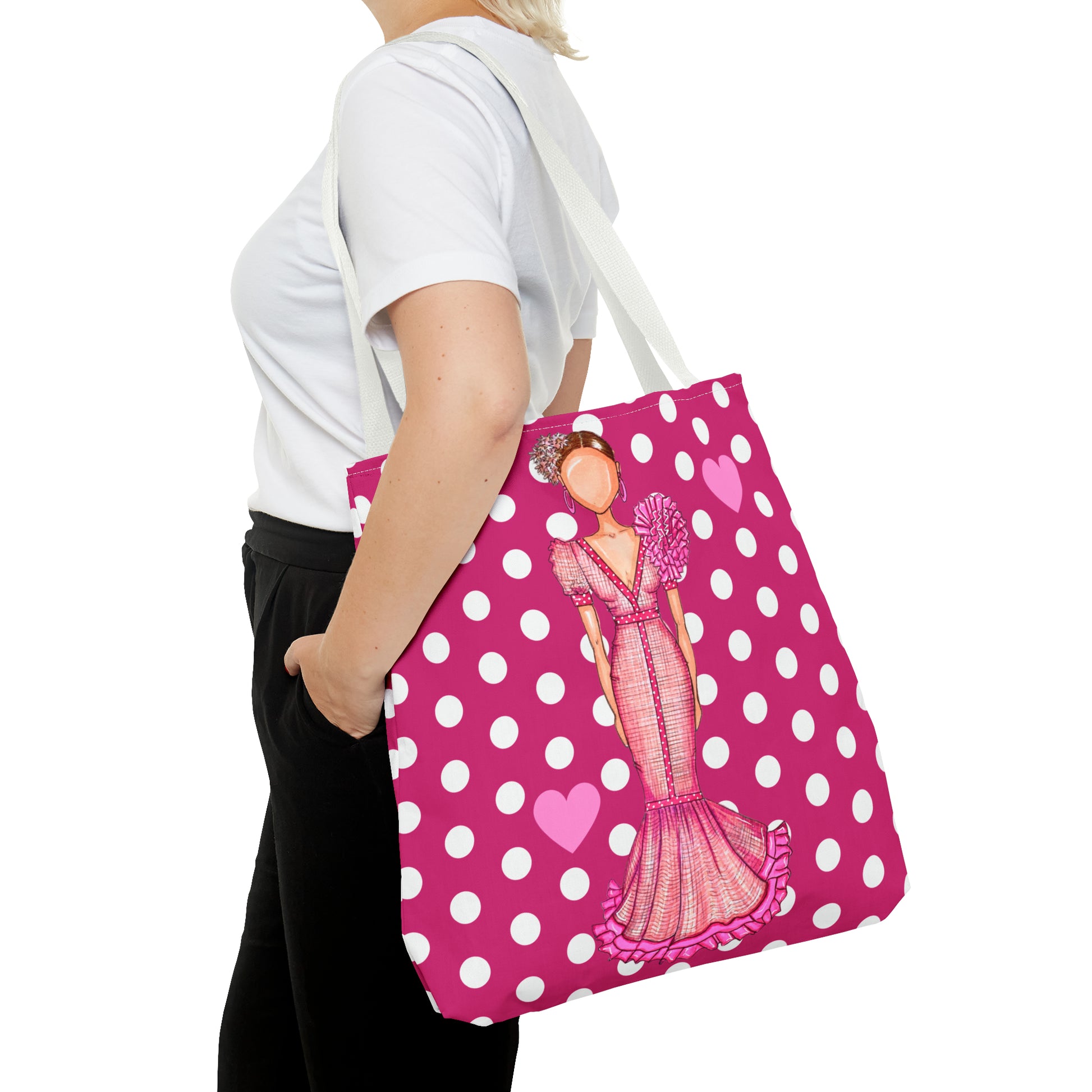 a woman carrying a pink and white polka dot bag