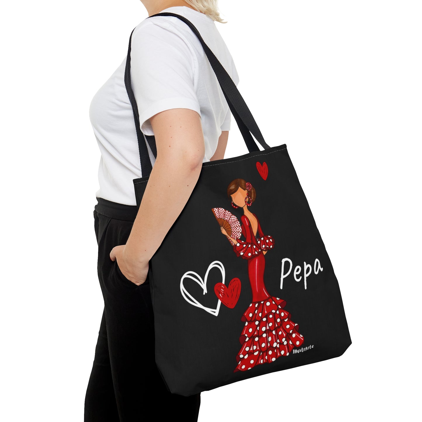 a woman carrying a black bag with a picture of a woman in a red dress