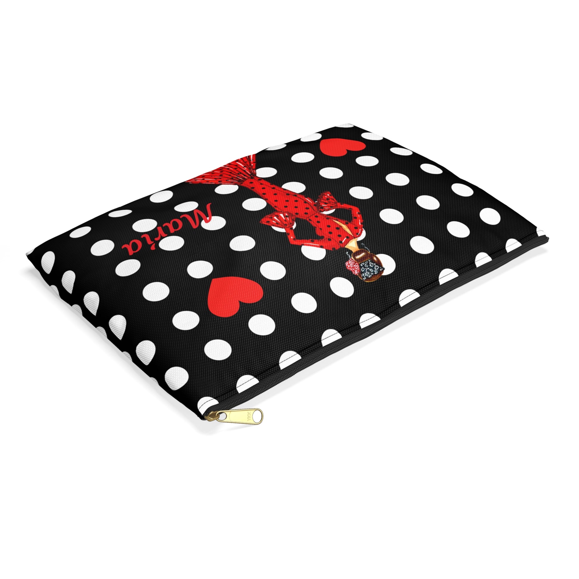 a black and white polka dot bag with a red bow