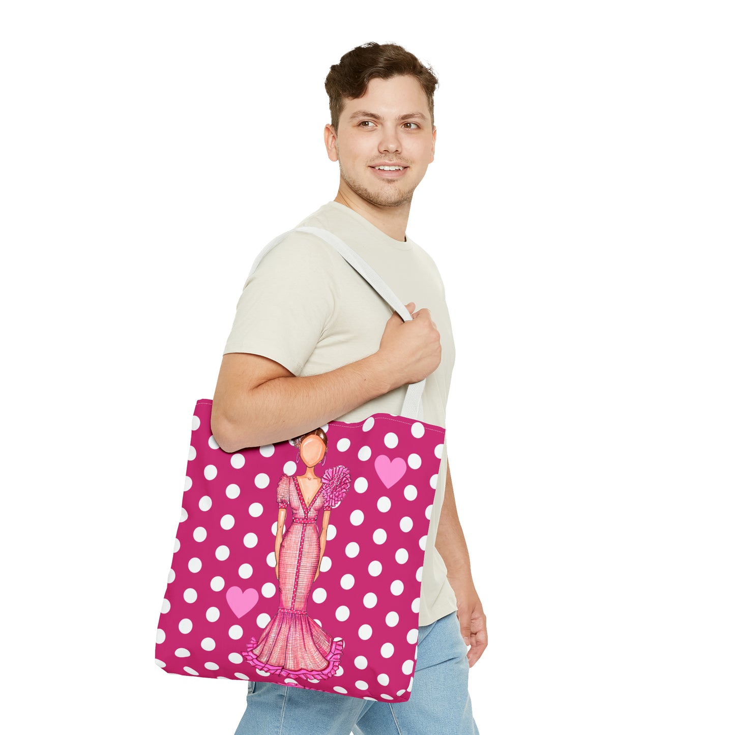 a man is holding a pink polka dot bag