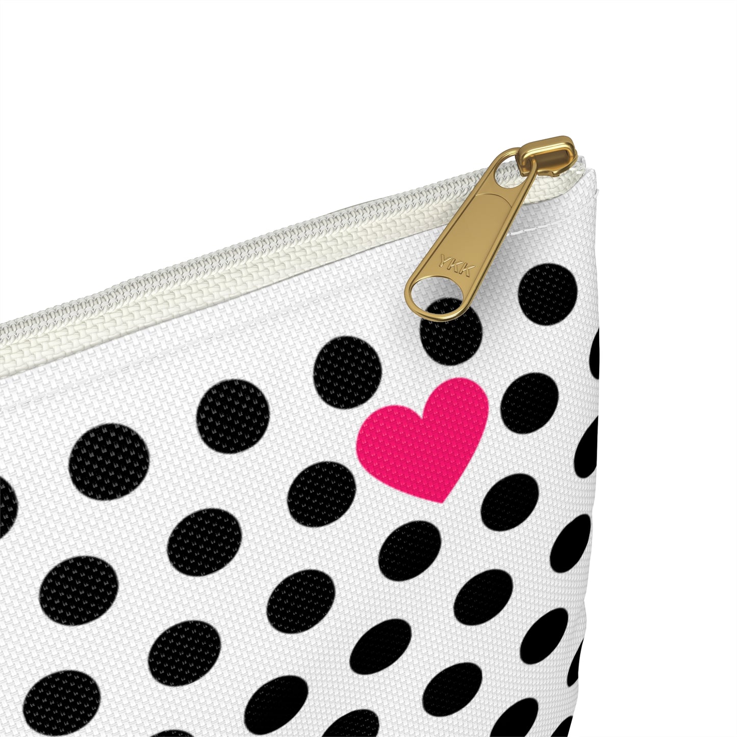 a black and white polka dot bag with a pink heart on it