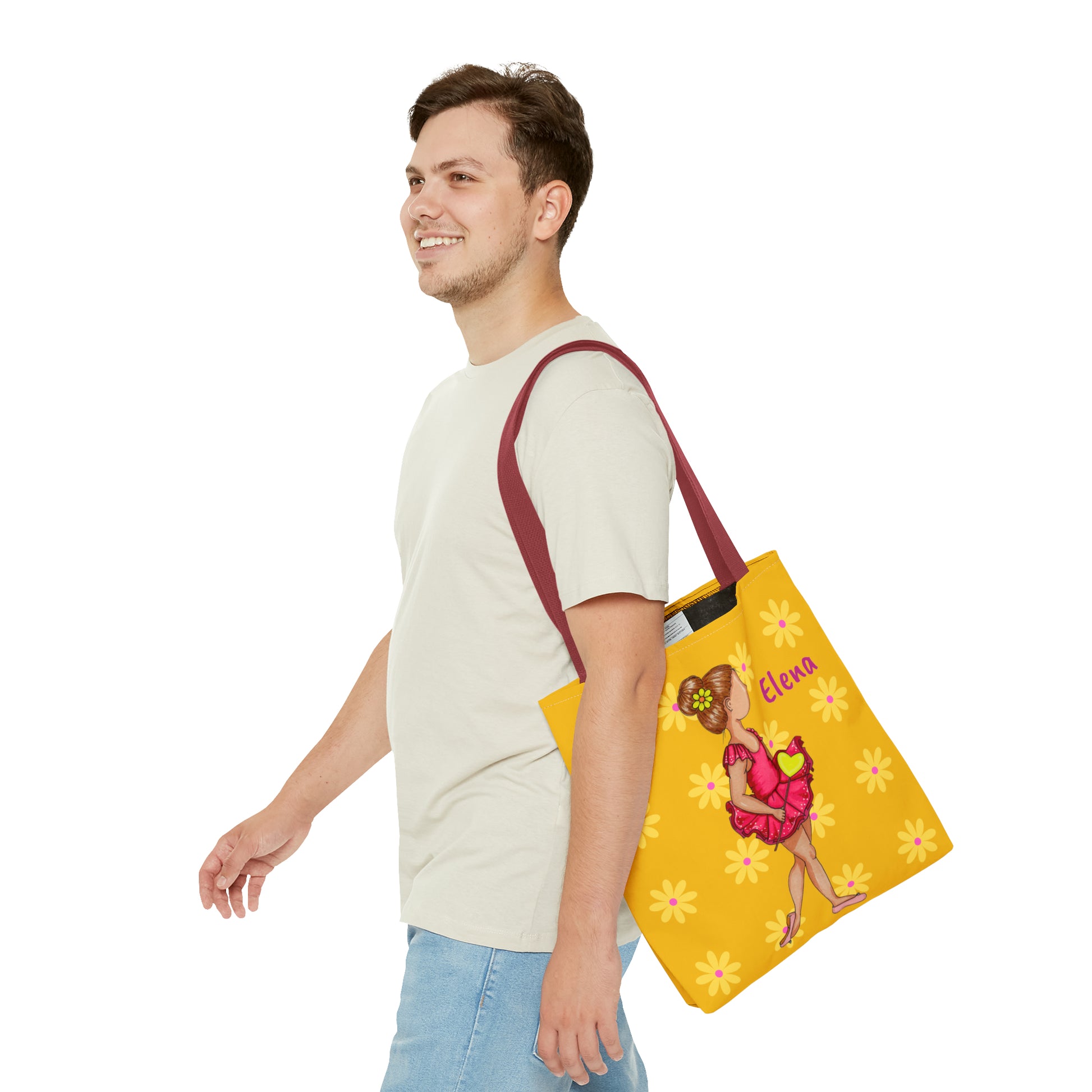 a man carrying a yellow bag with a picture of a girl on it