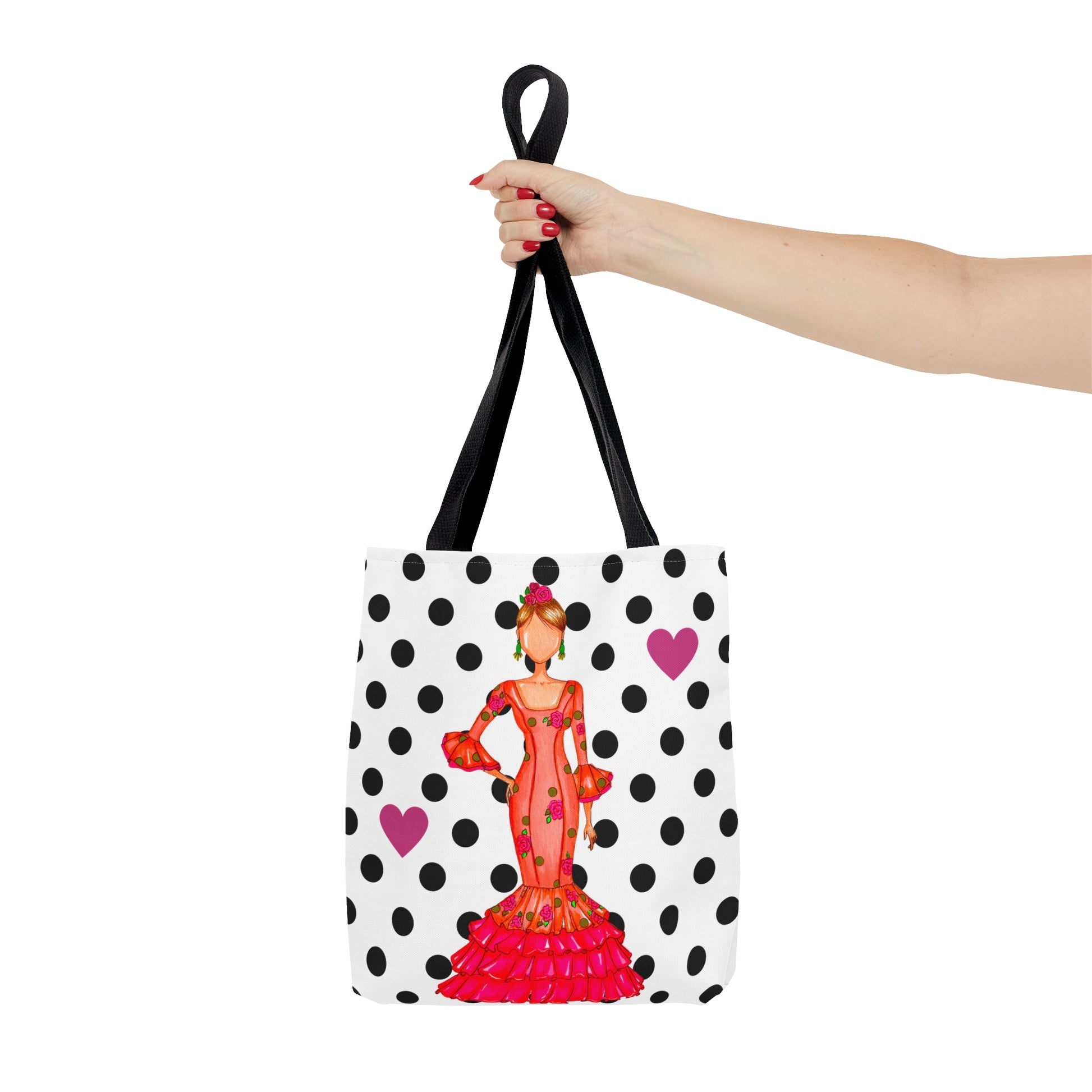 a woman's hand holding a tote bag with a picture of a woman