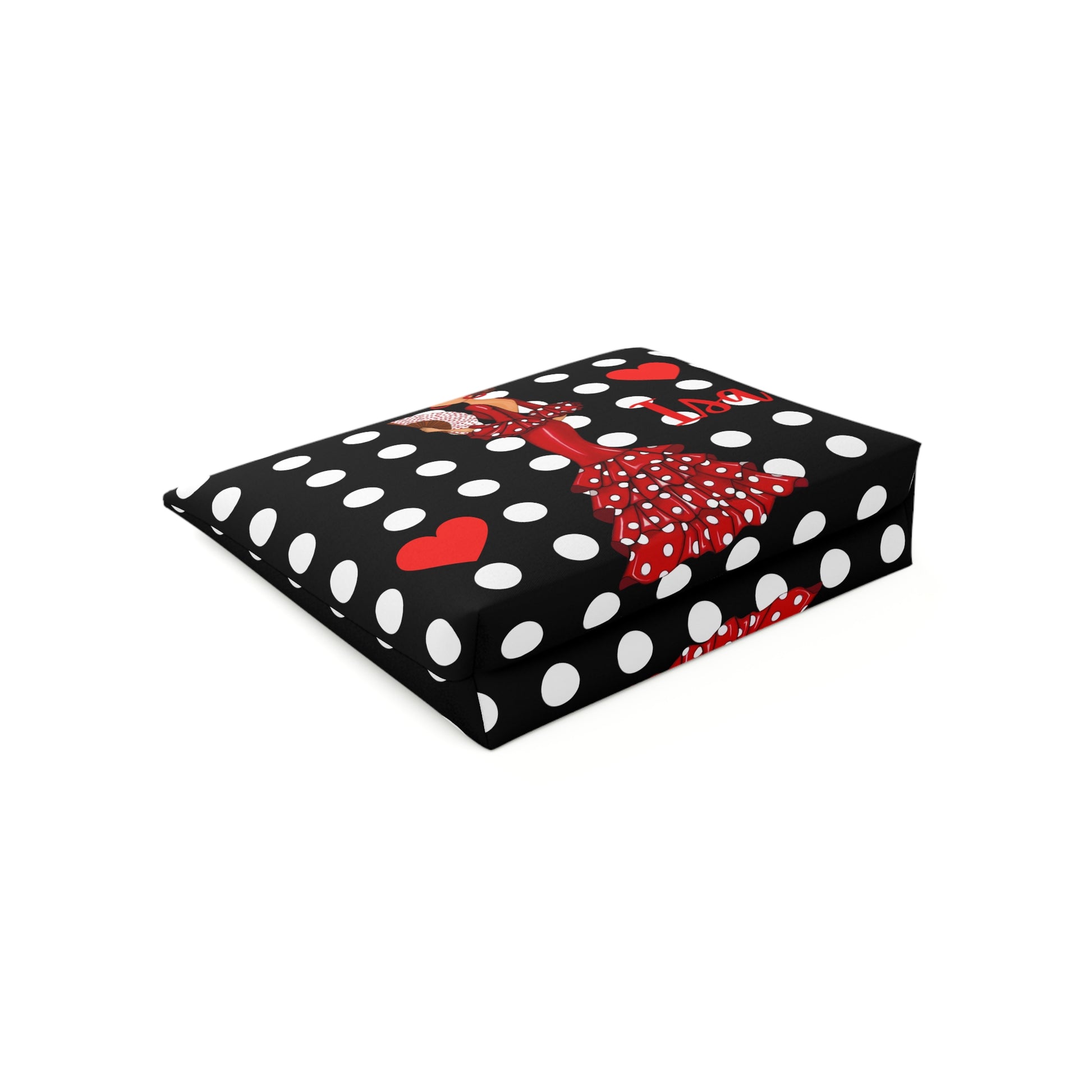 a black and white polka dot box with a red bow