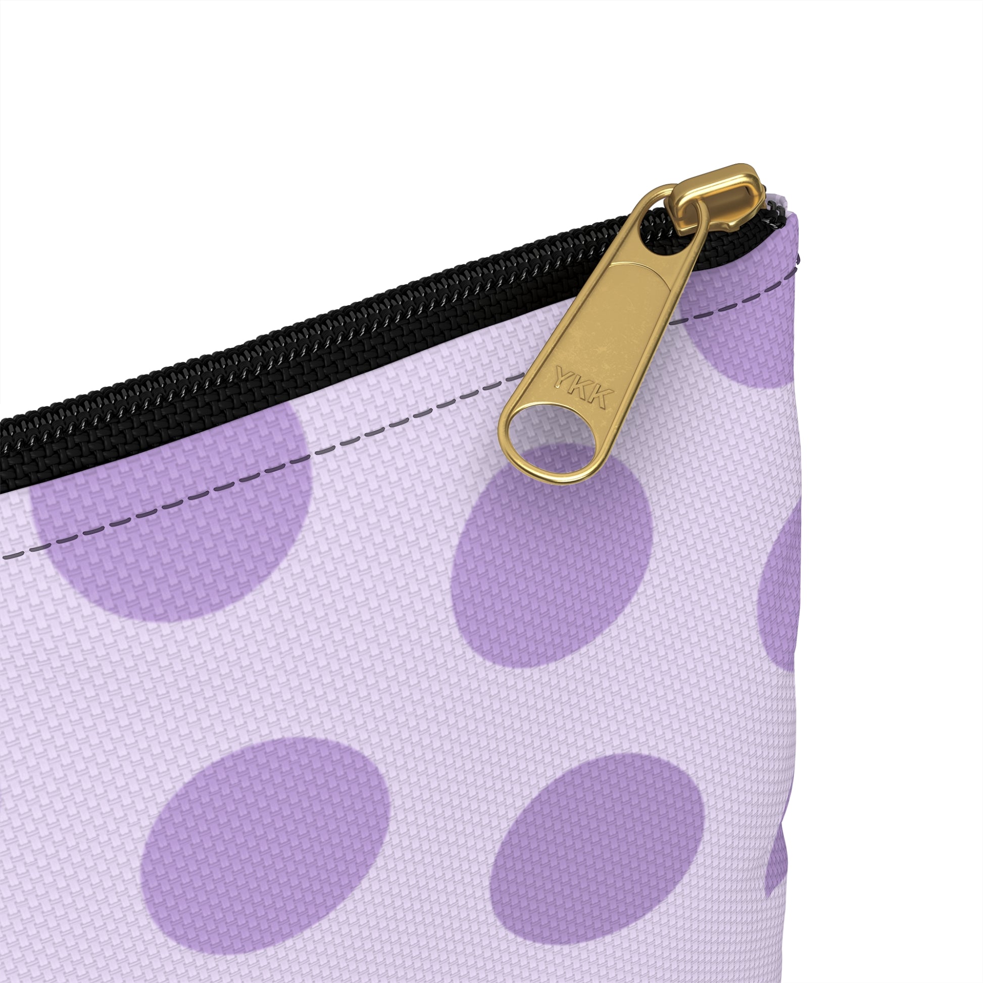 a purple and white polka dot purse with a gold zipper
