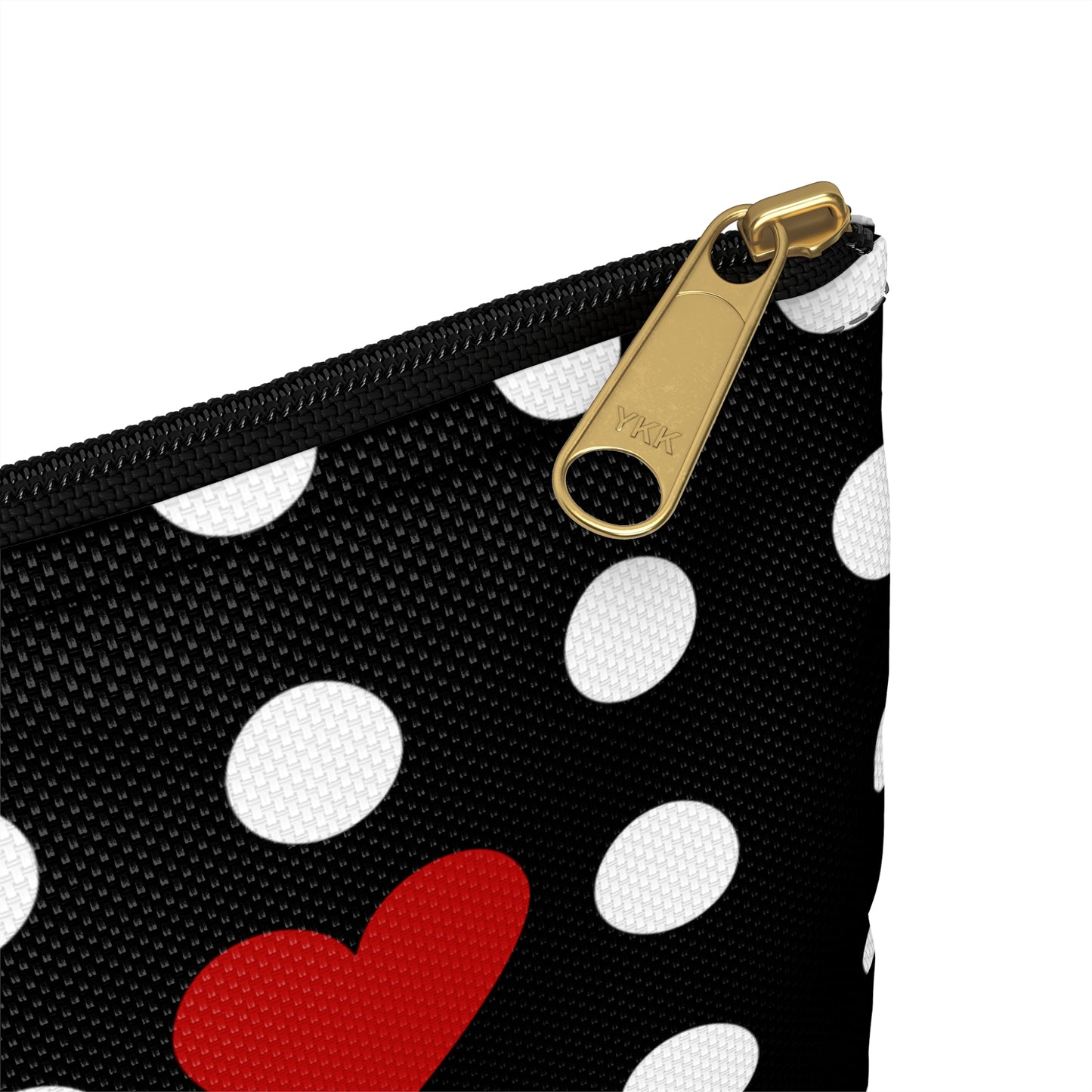 a black and white polka dot purse with a red heart on it