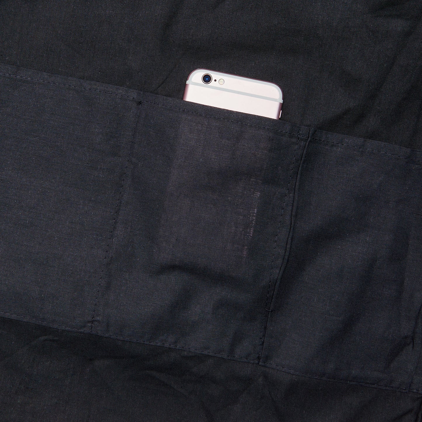 a cell phone in the pocket of a black jacket