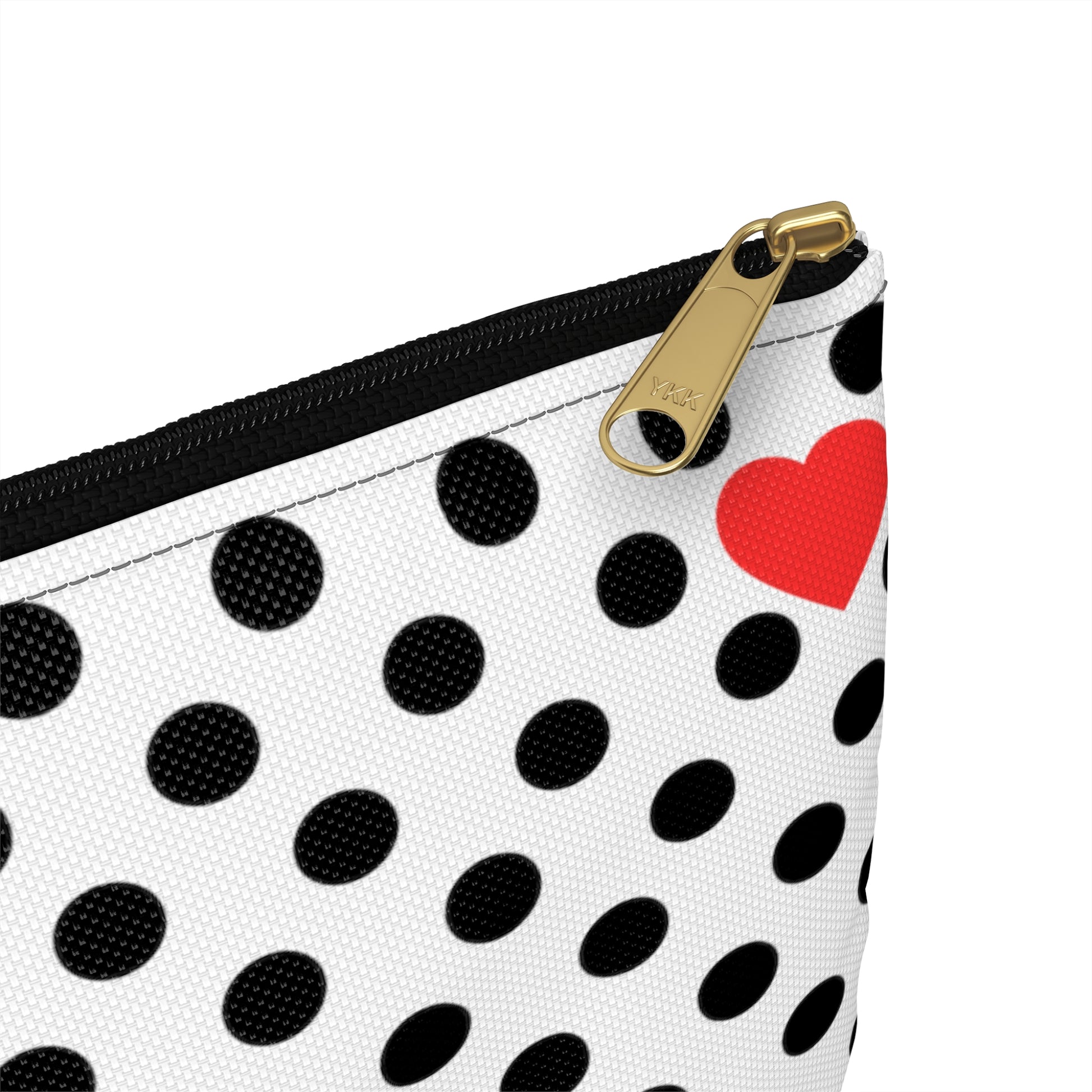 a black and white polka dot purse with a red heart on it