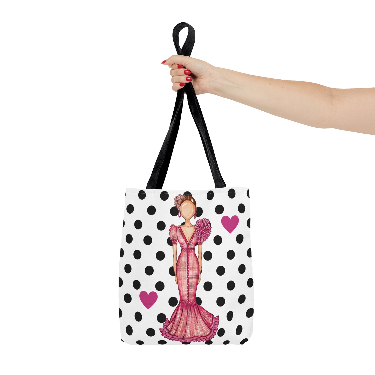a woman's hand holding a polka dot purse