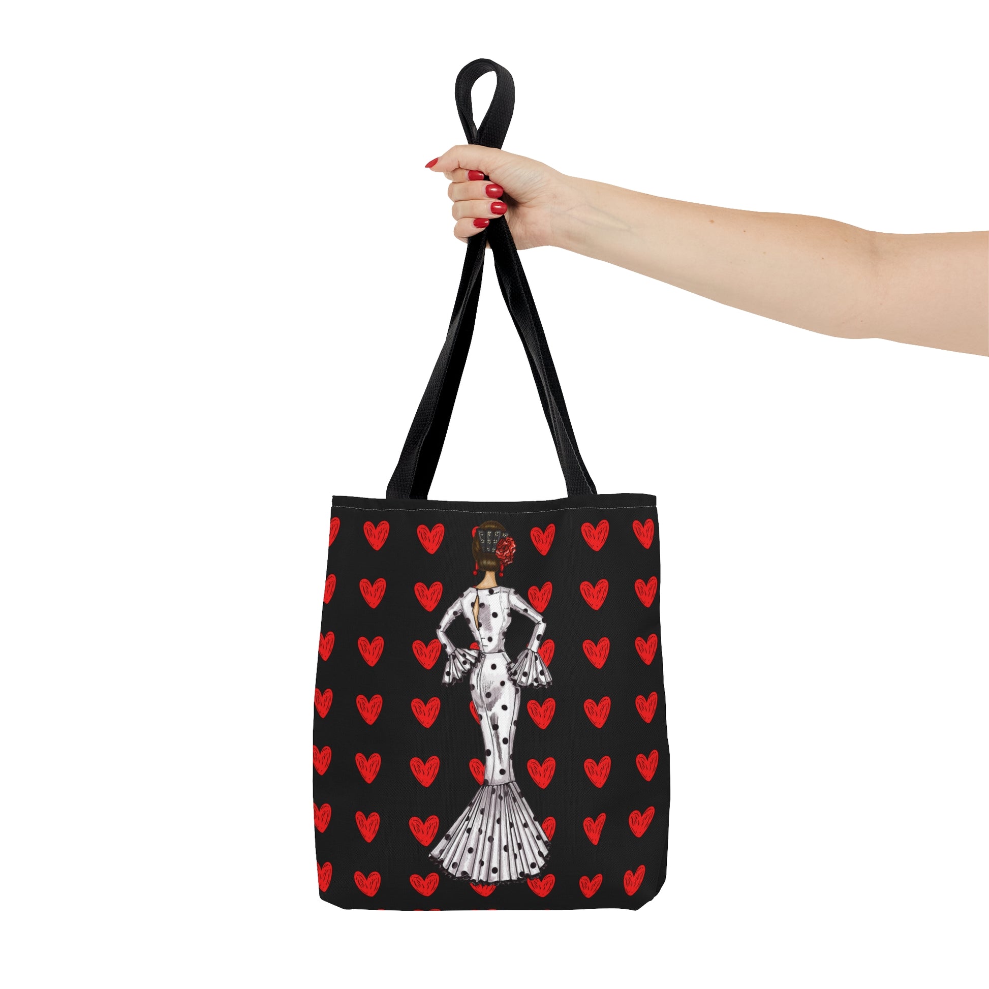 a woman's hand holding a black and red bag with a dalmatian