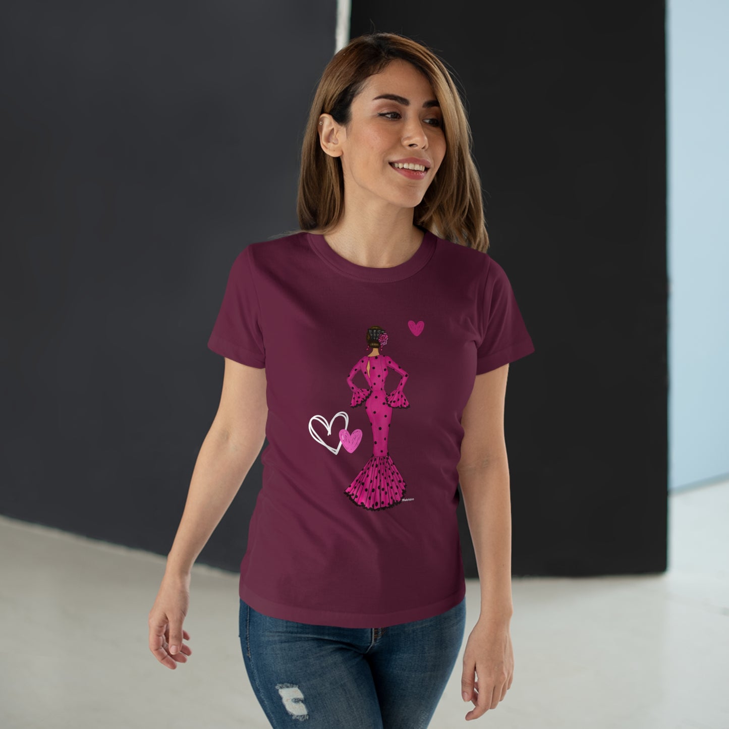 a woman wearing a t - shirt with a pink design on it