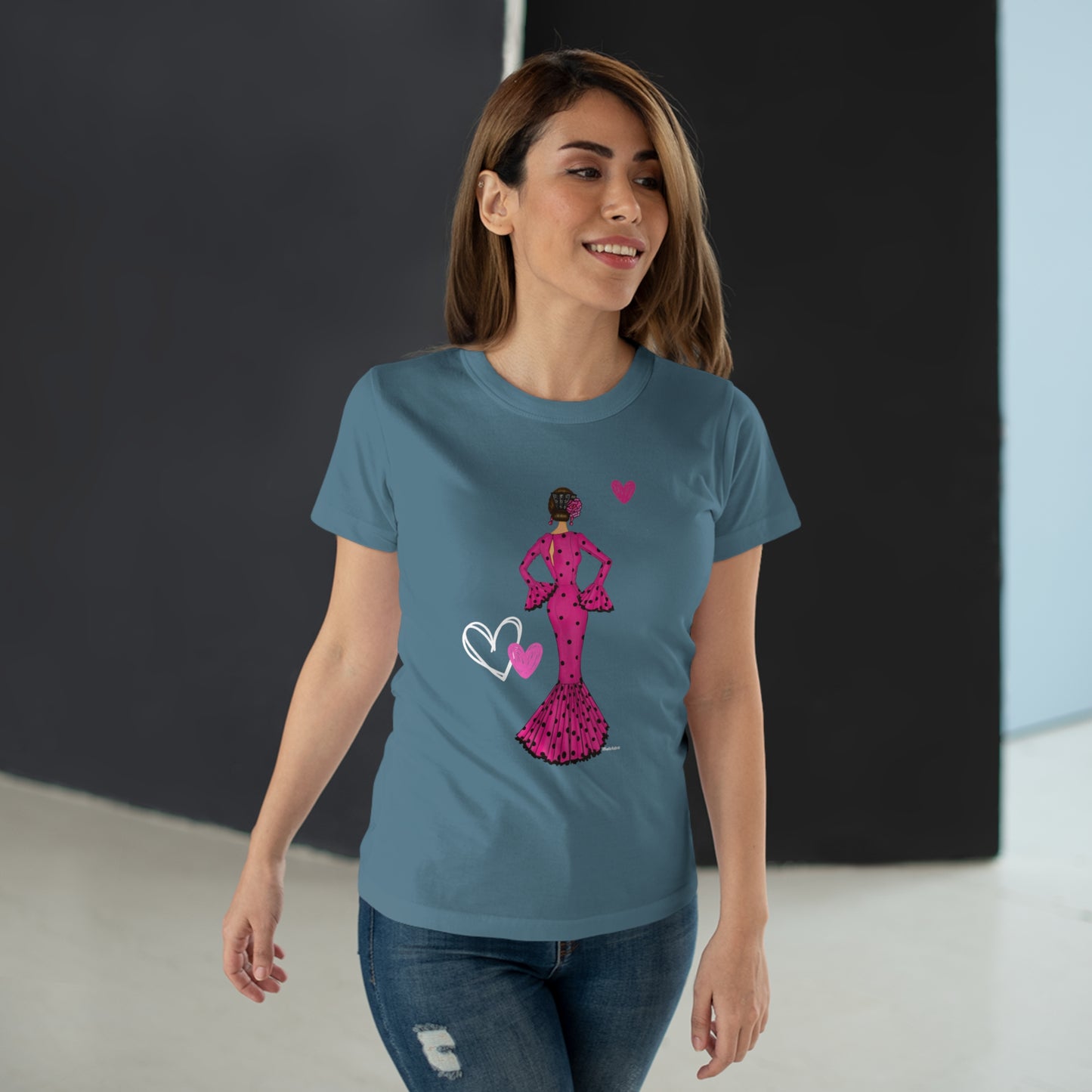 a woman wearing a blue t - shirt with a pink design on it