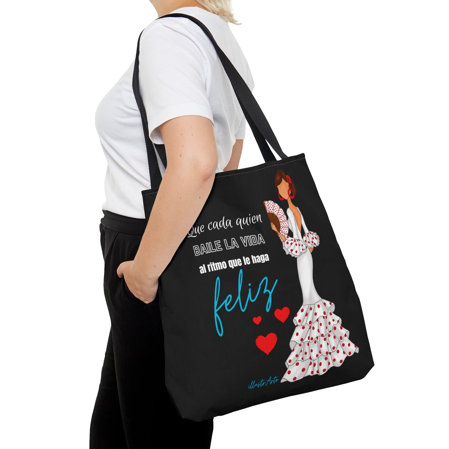 a woman carrying a black tote bag with a picture of a woman in a