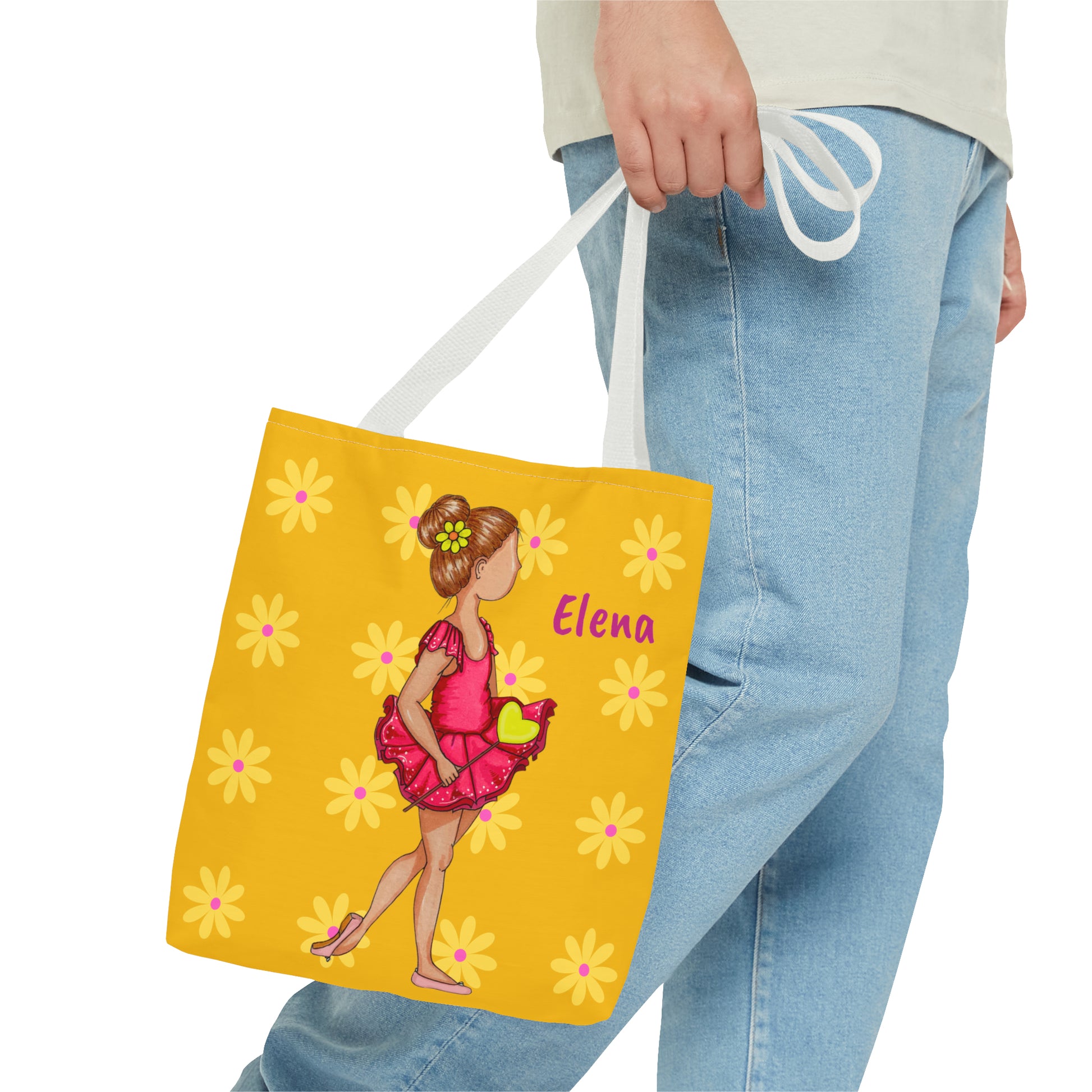 a woman carrying a yellow bag with a picture of a girl on it