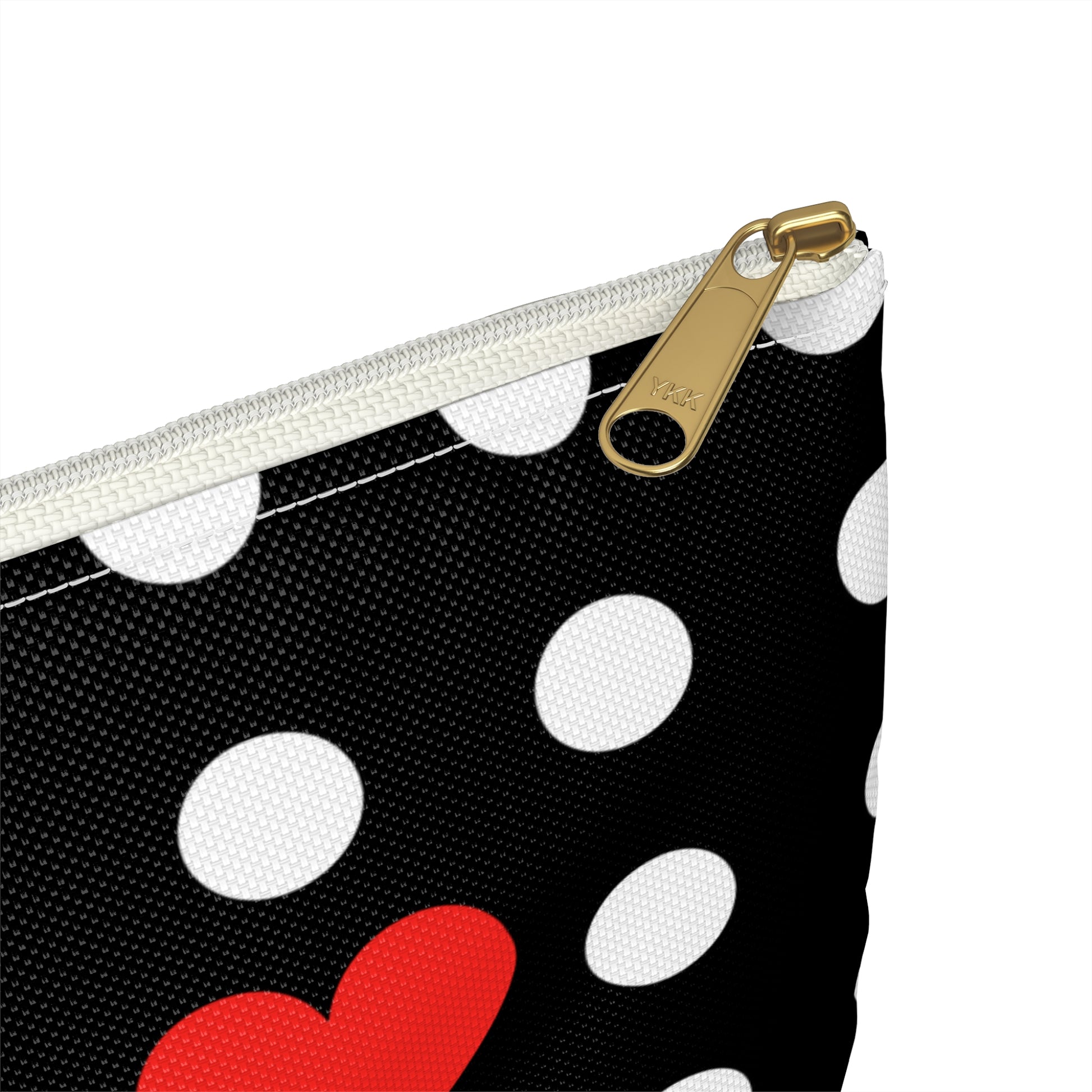a black and white polka dot purse with a red heart