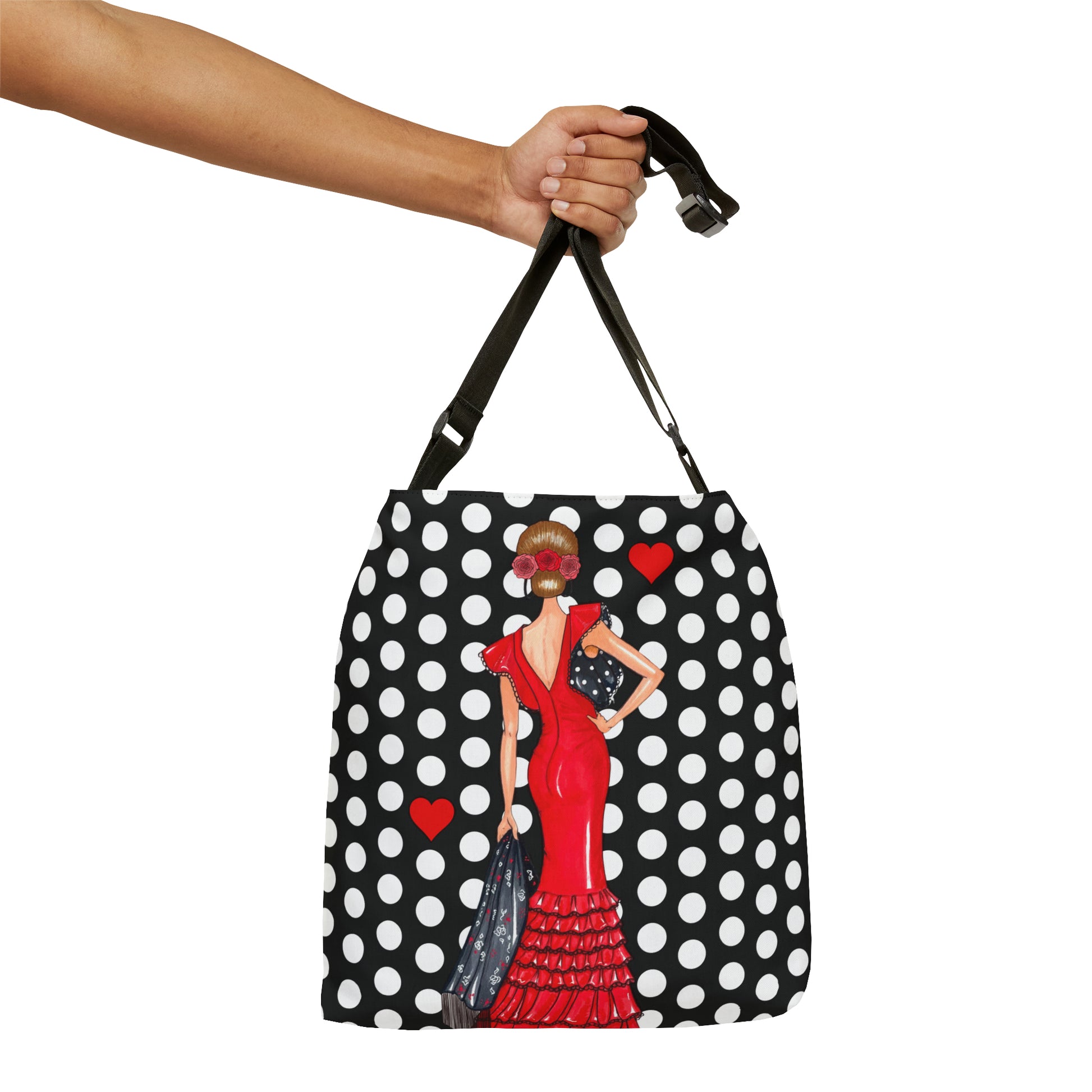 a hand holding a black and white polka dot purse