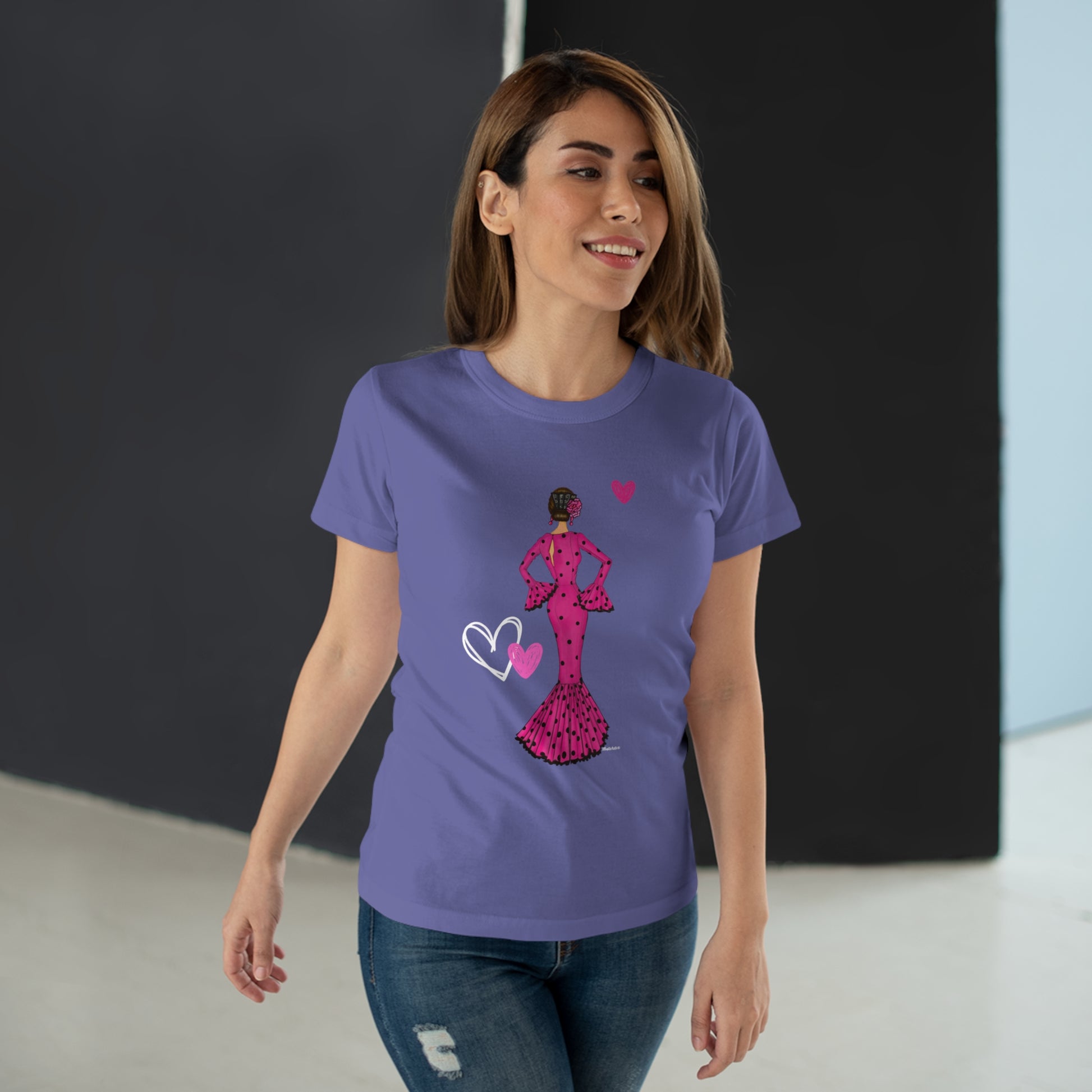 a woman wearing a purple t - shirt with a pink heart on it