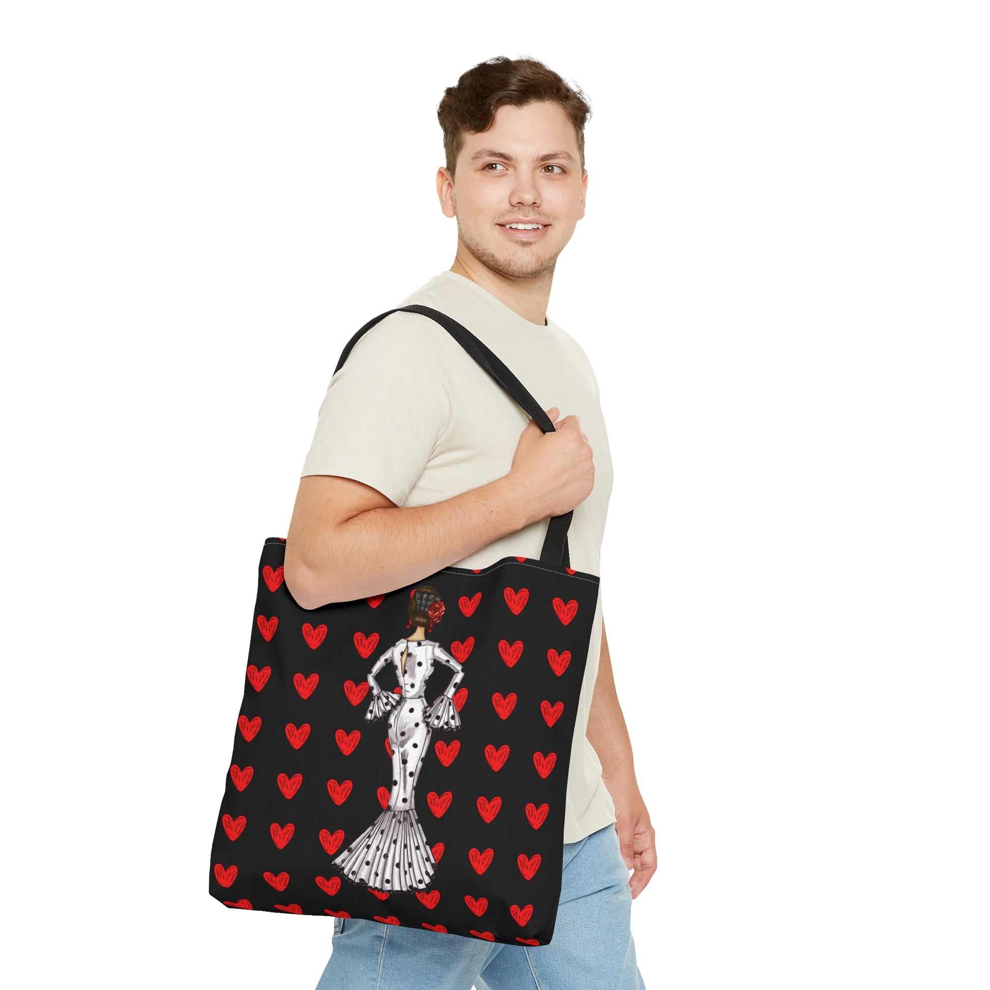 a man holding a black and red bag with hearts on it