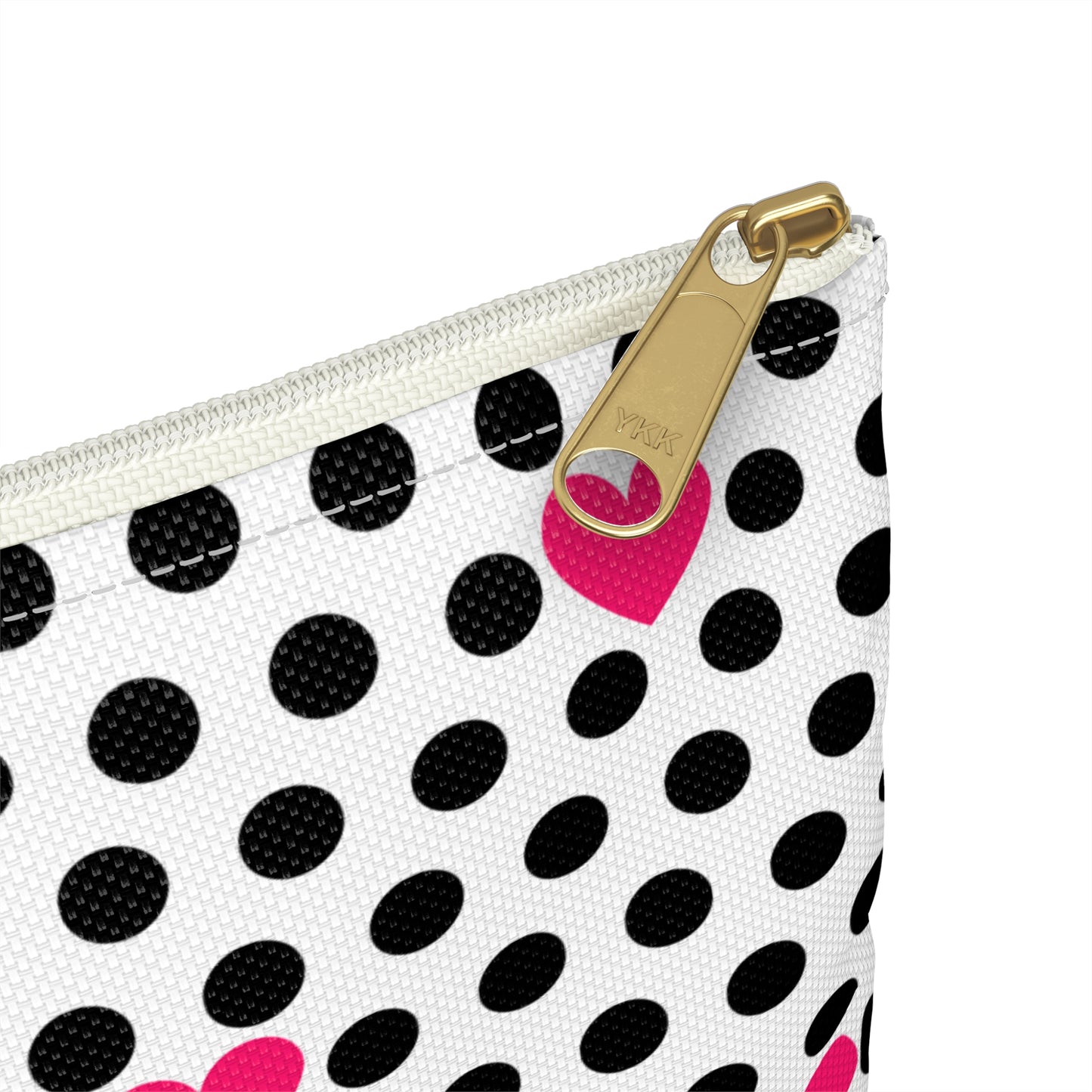 a black and white polka dot purse with a pink heart on it