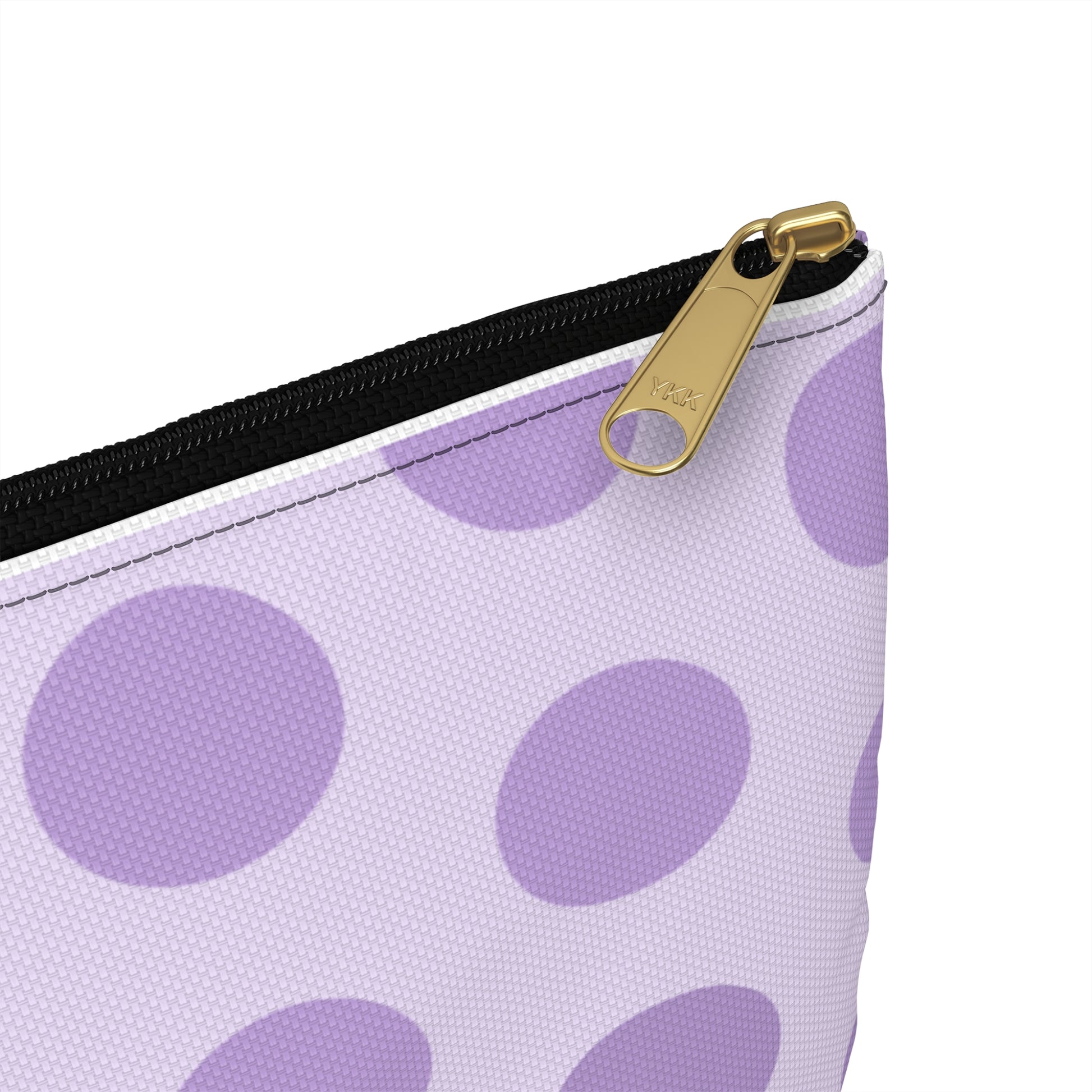 a purple and white polka dot purse with a gold zipper