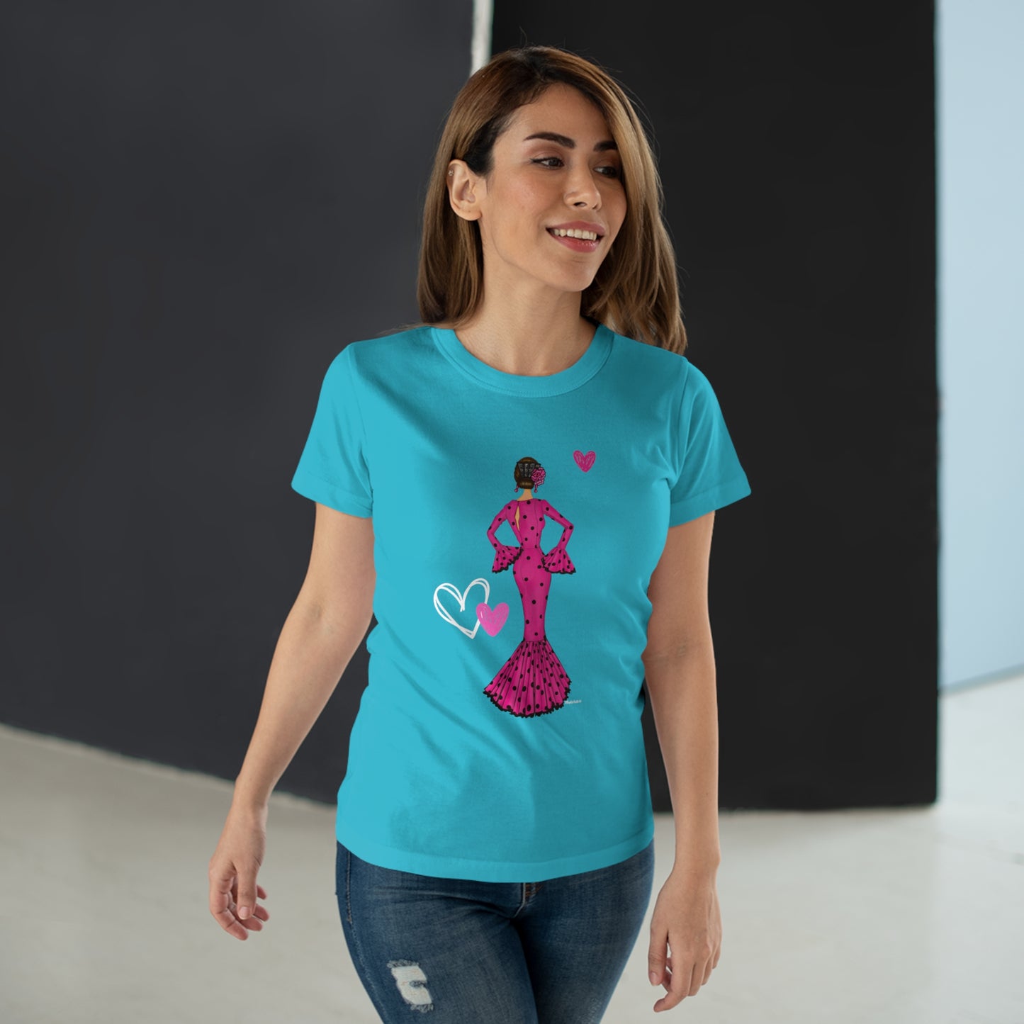 a woman wearing a blue t - shirt with a pink dress on it