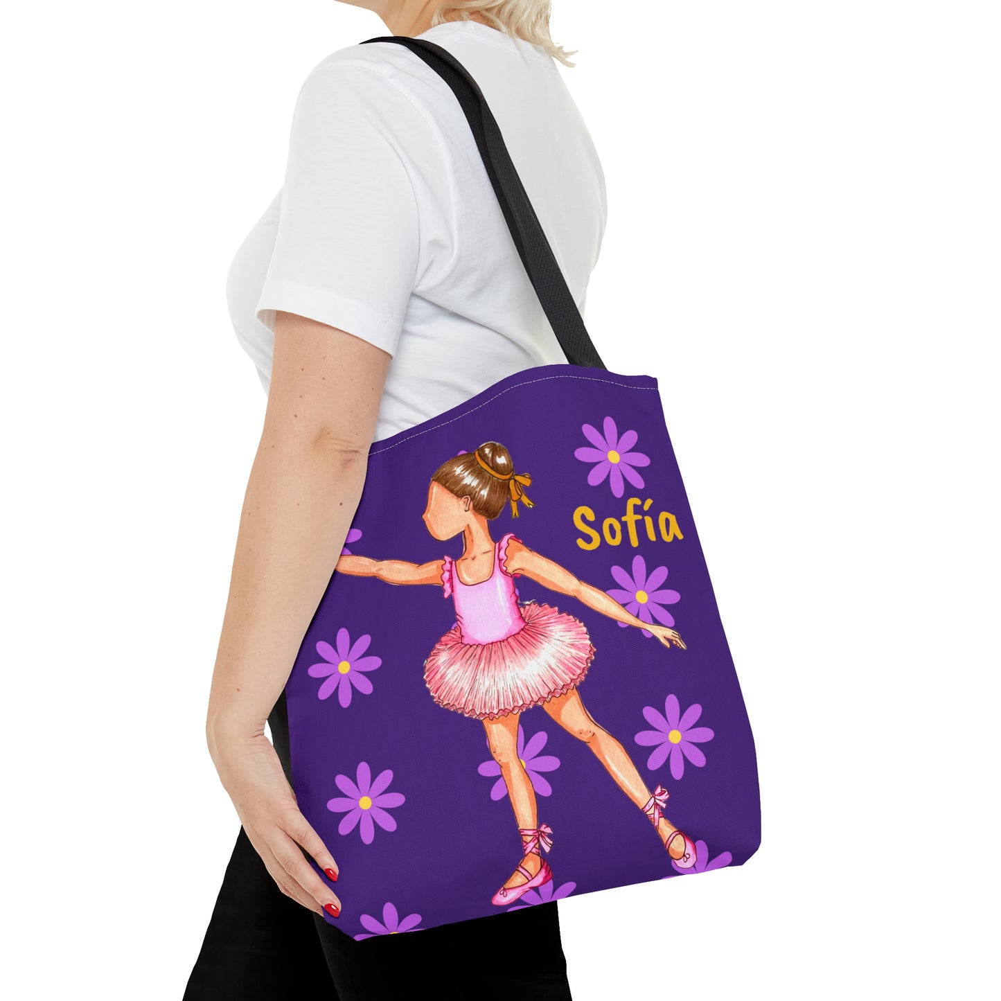 a woman carrying a purple tote bag with a picture of a ballerina