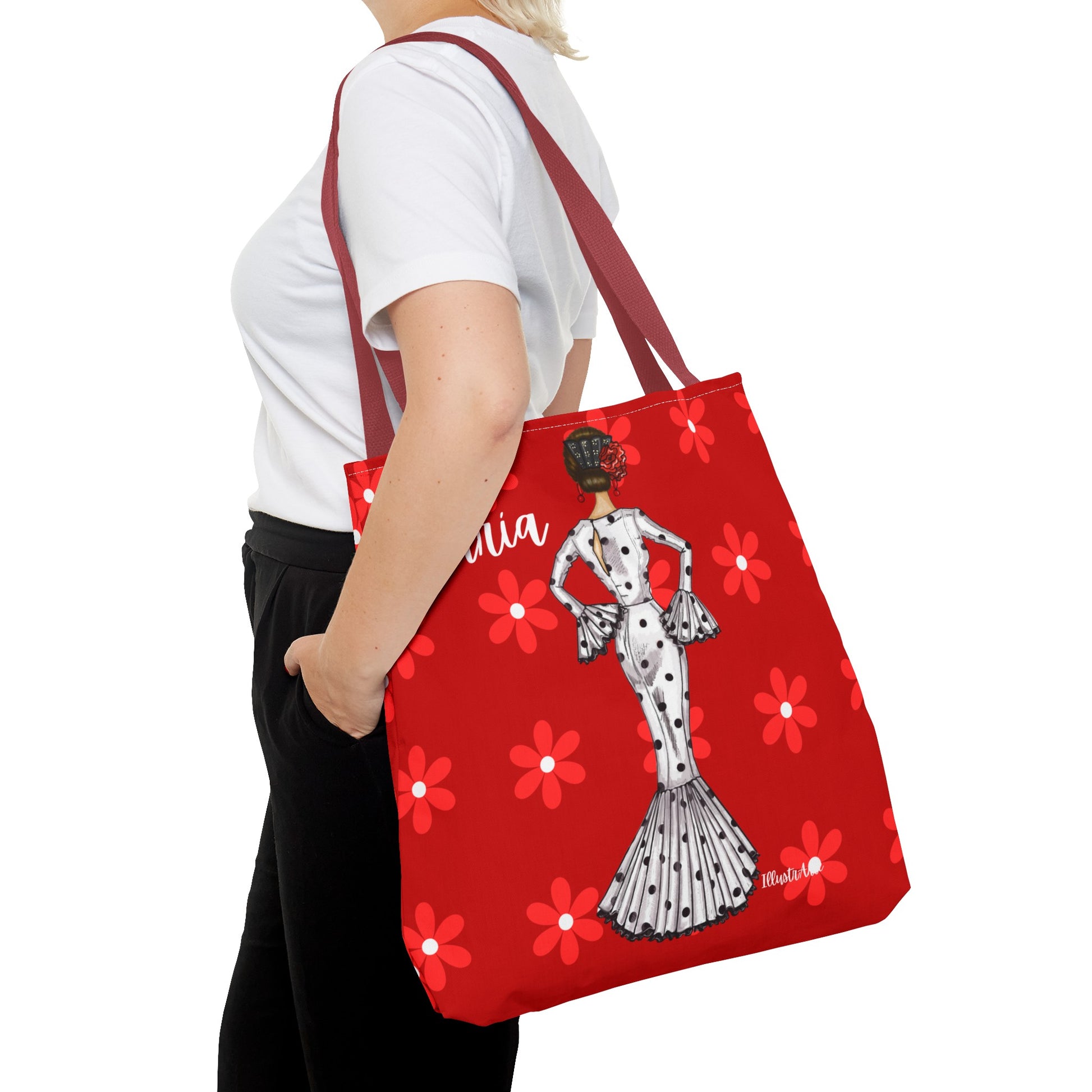 a woman carrying a red bag with a picture of a woman on it