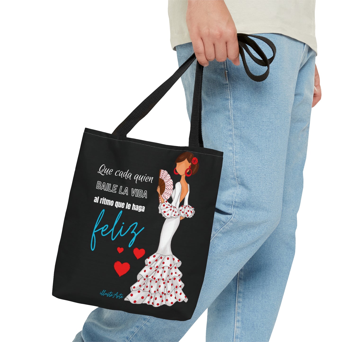 a woman carrying a black tote bag with a picture of a woman in a
