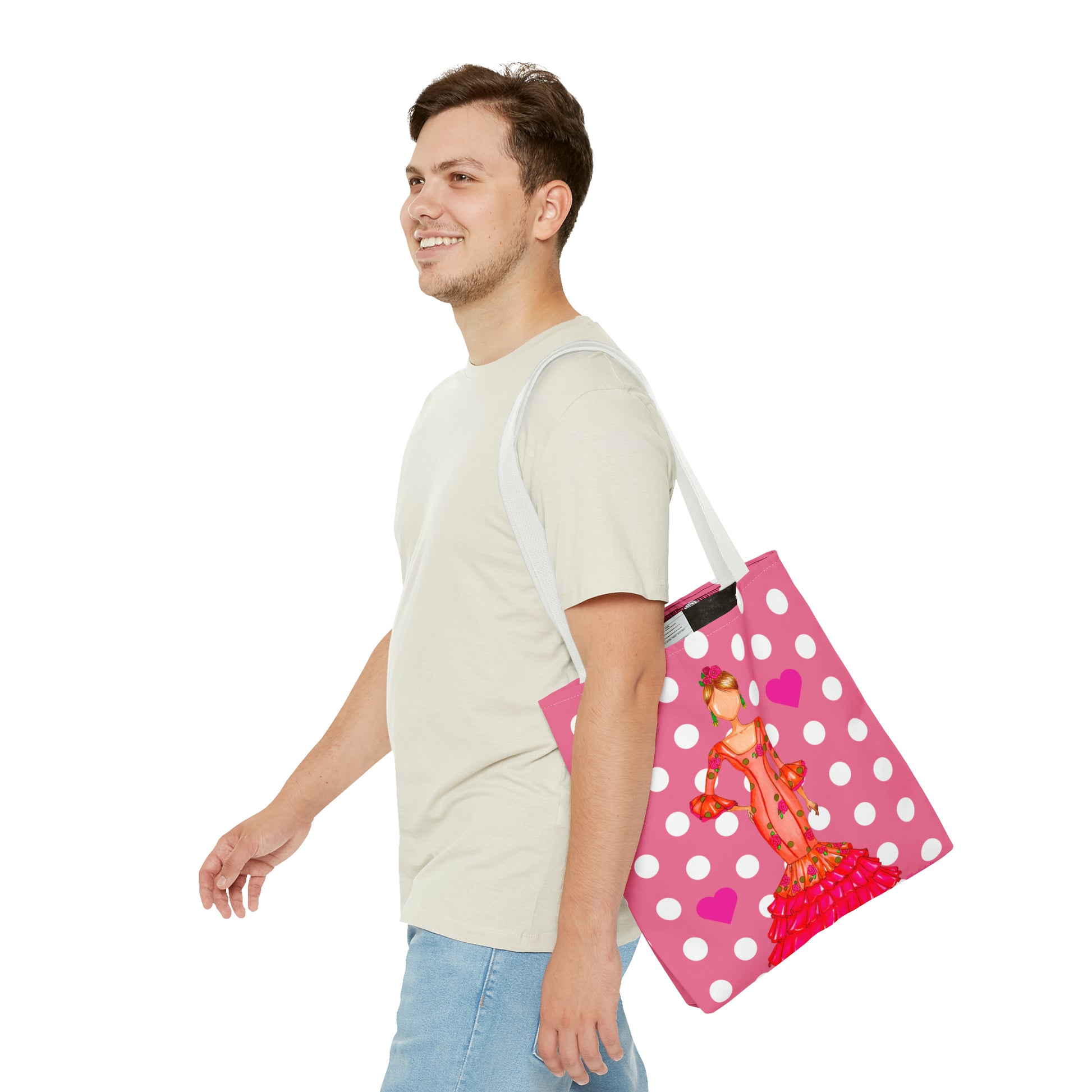 a man carrying a pink and white polka dot bag