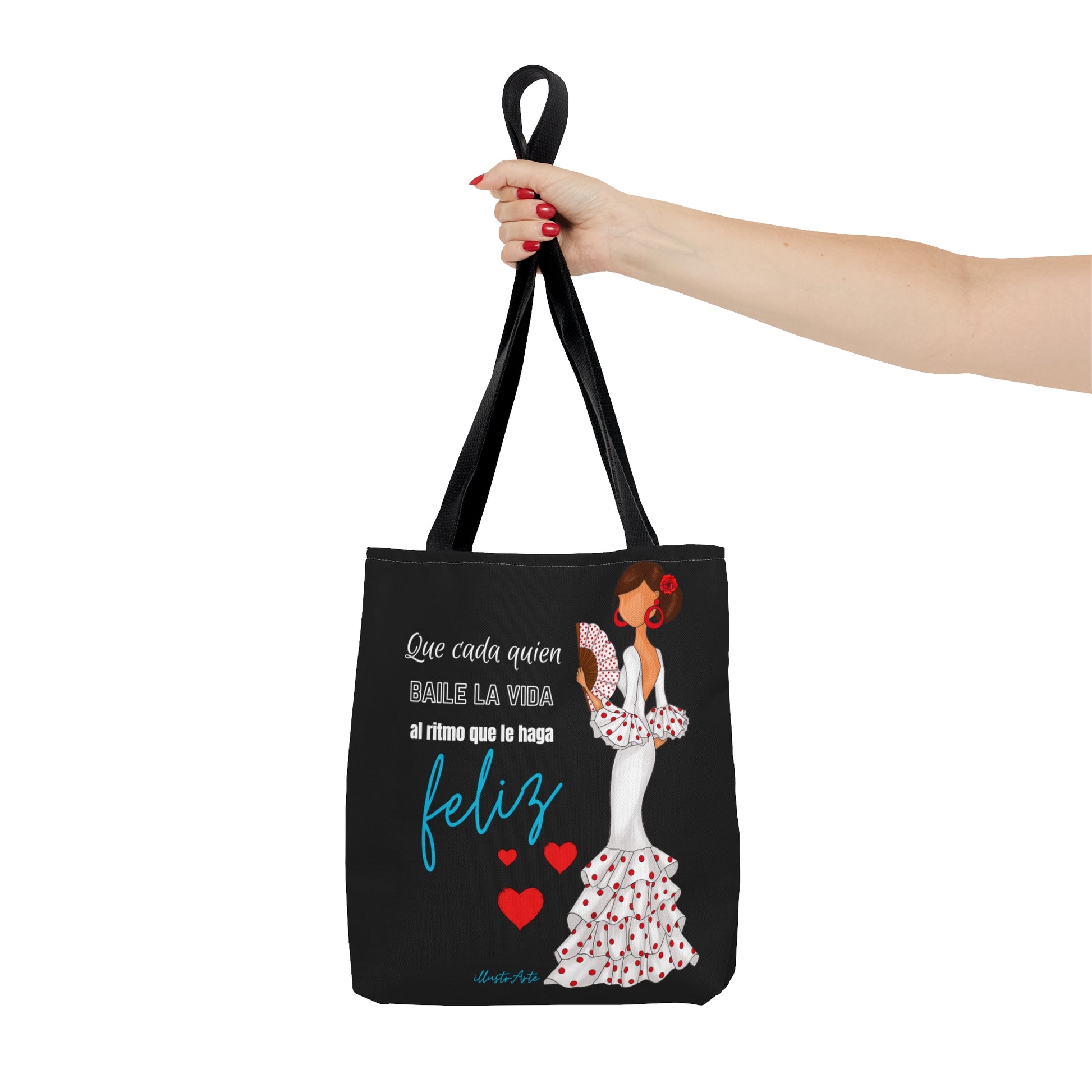 a woman holding a black tote bag with a picture of a woman in a