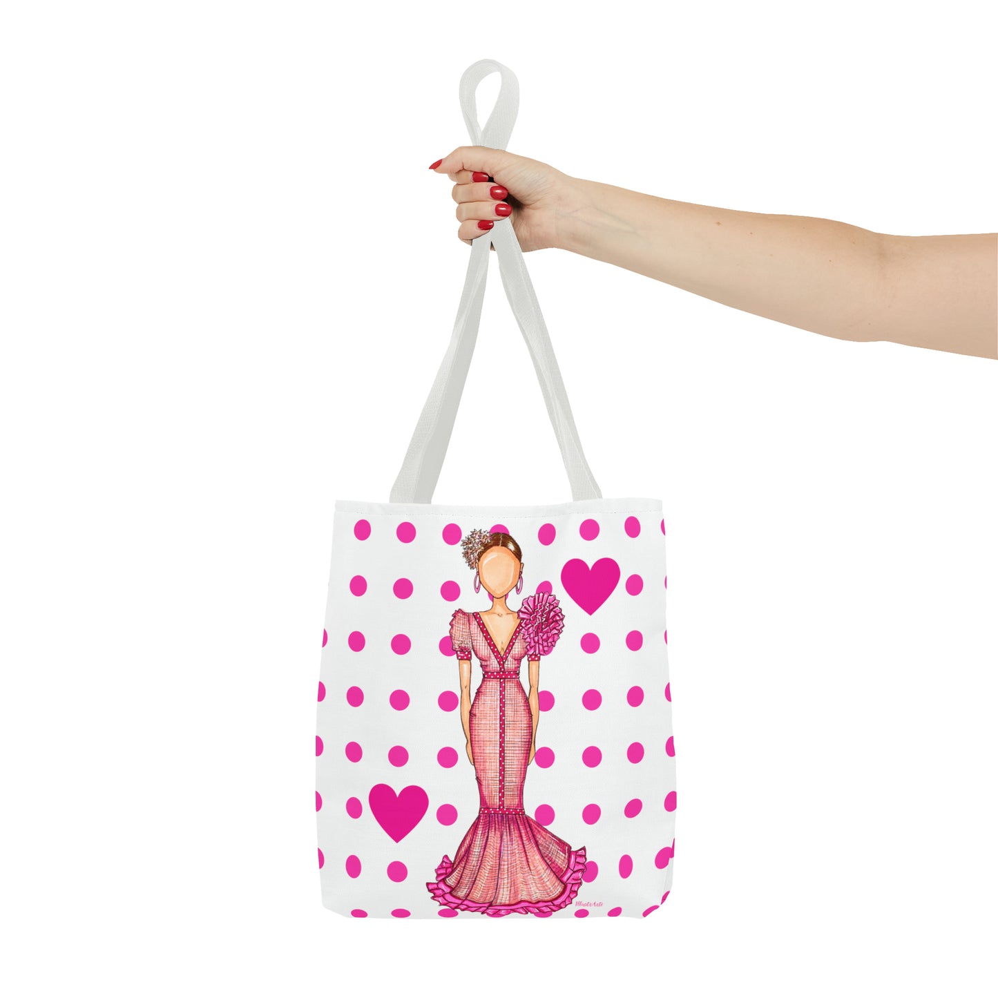 a woman's hand holding a pink and white bag with a picture of a