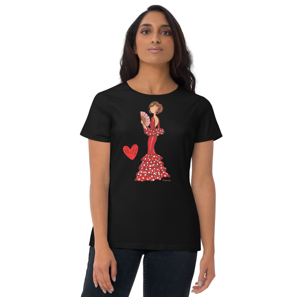 a woman wearing a black t - shirt with a red heart on it