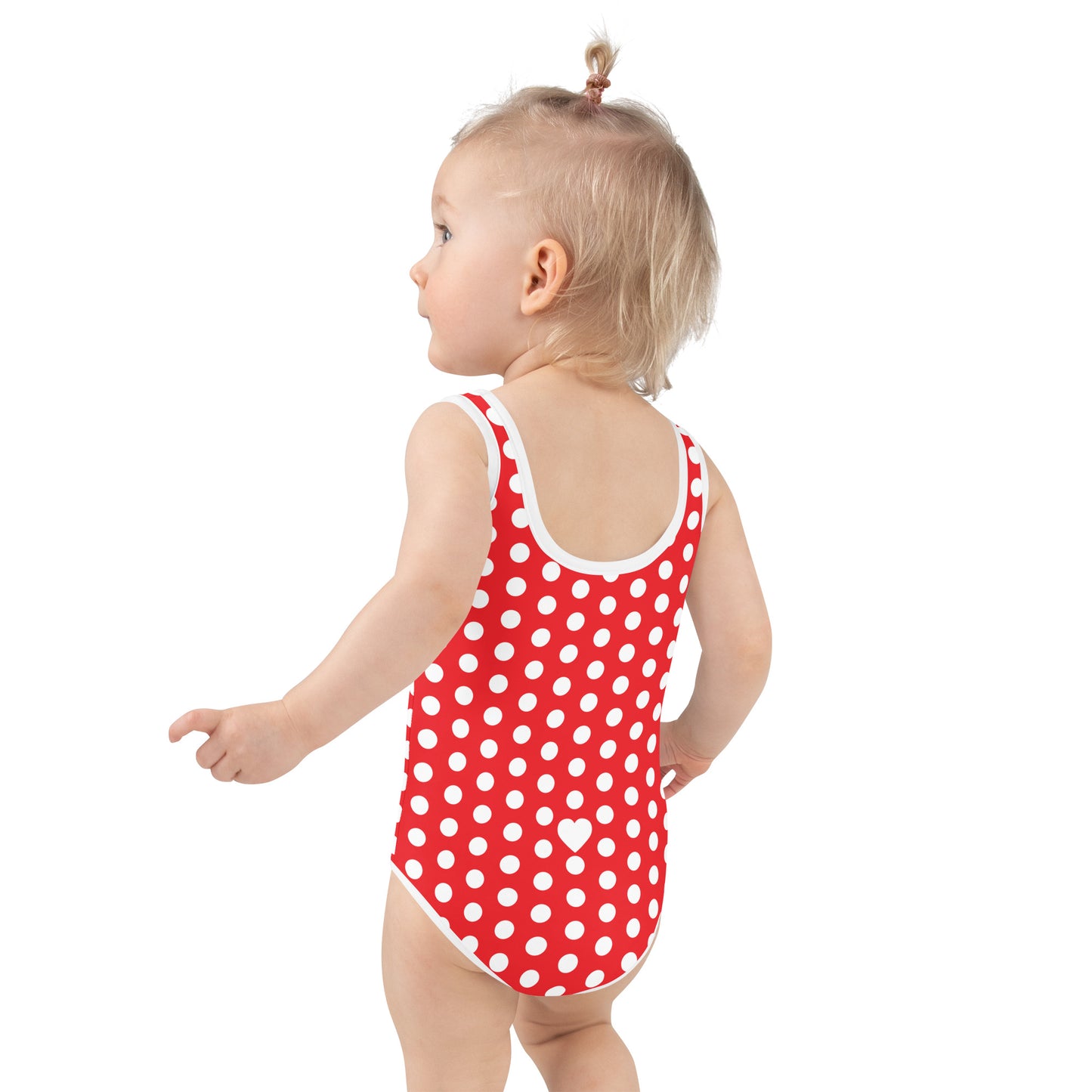 a baby in a red and white polka dot swimsuit