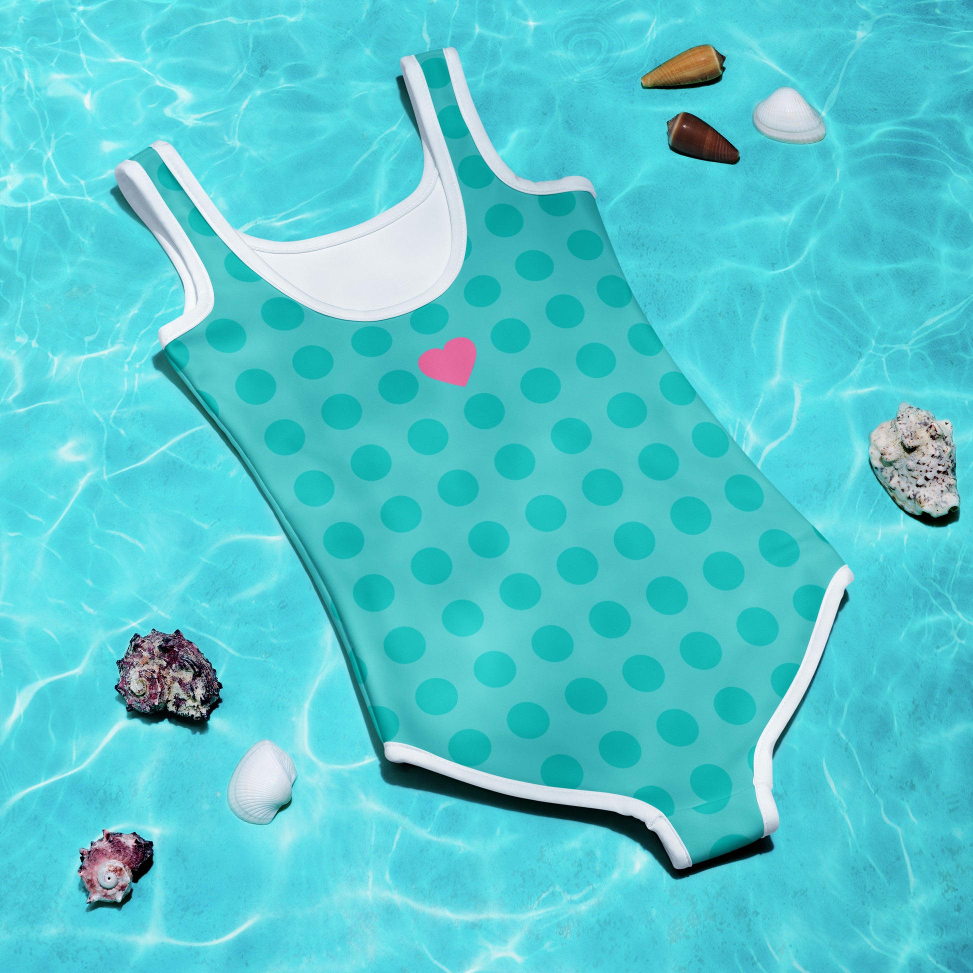 a bathing suit with a heart on it laying in a pool of water
