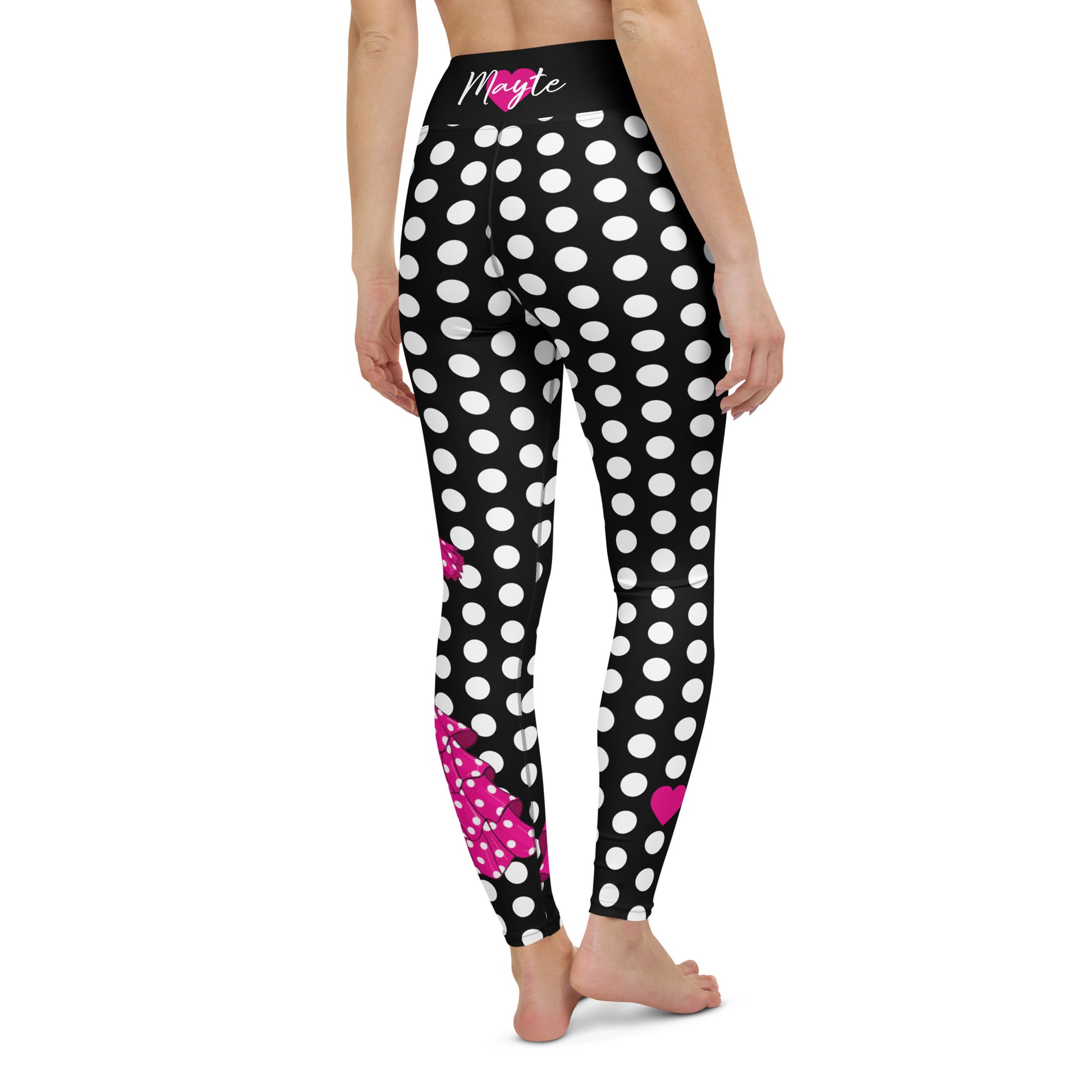 a woman wearing black and white polka dot leggings