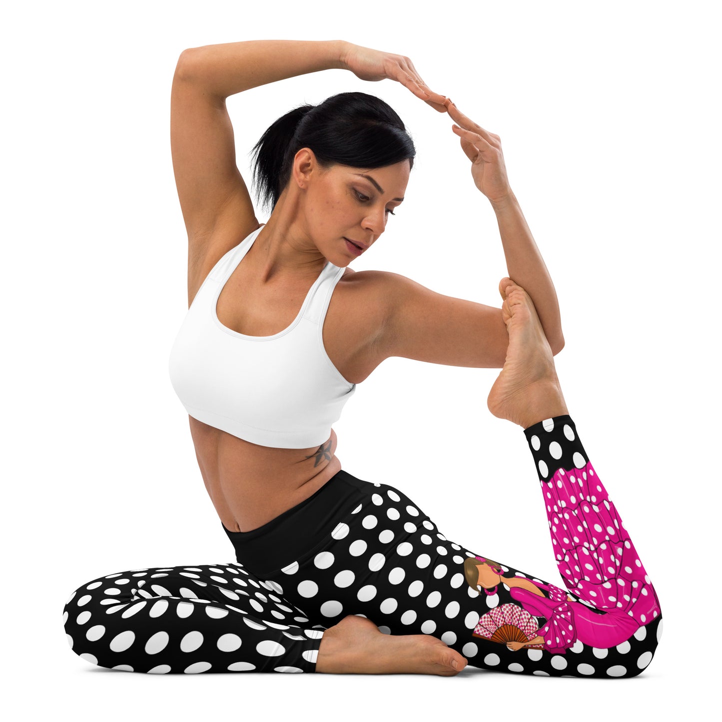 a woman in a white top and polka dot leggings