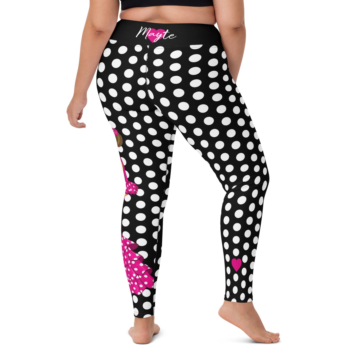 a woman wearing black and white polka dot print leggings