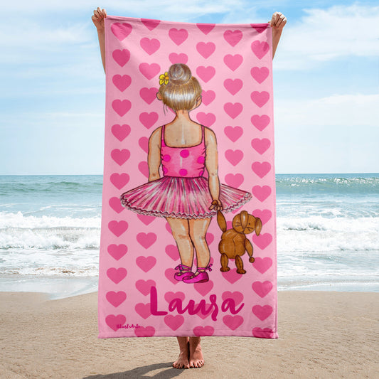 a woman holding a pink towel with a picture of a ballerina on it