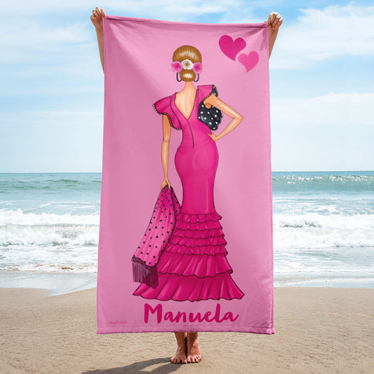 a woman in a pink dress holding a pink towel